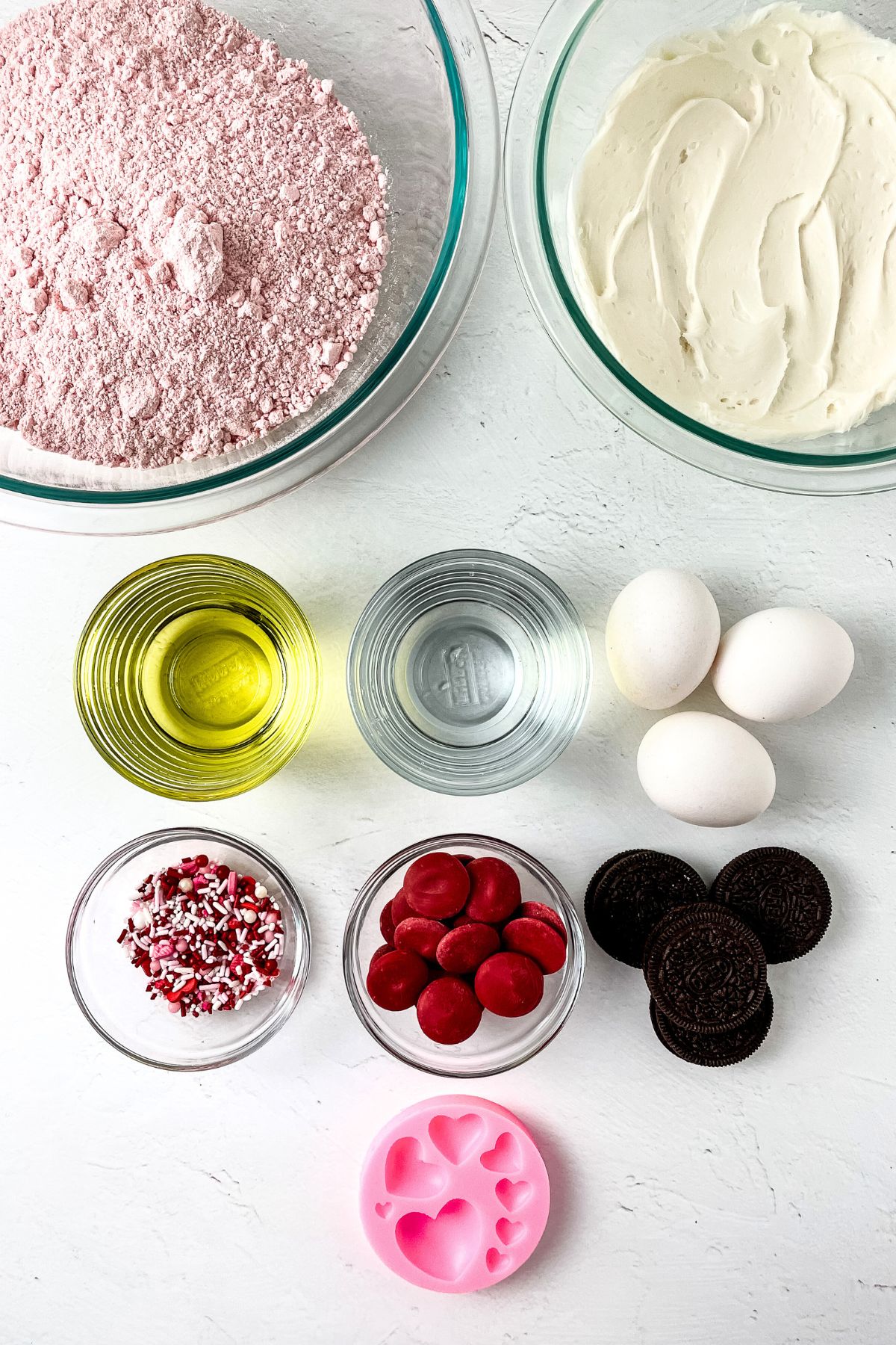 Strawberry cookies and cream cupcake ingredients on a counter.