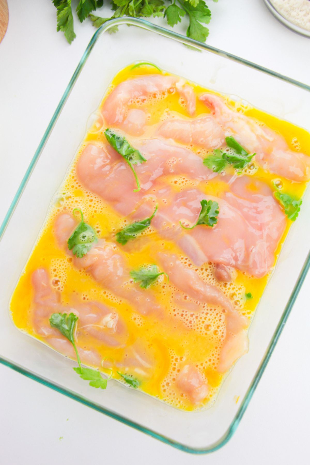 Chicken in bowl of eggs.