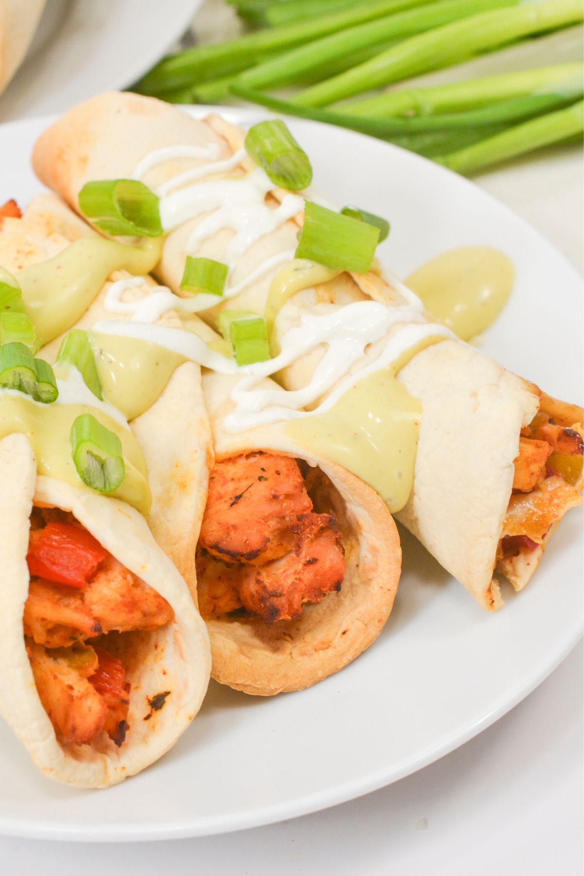 Air fryer green chile chicken taquitos on a plate.