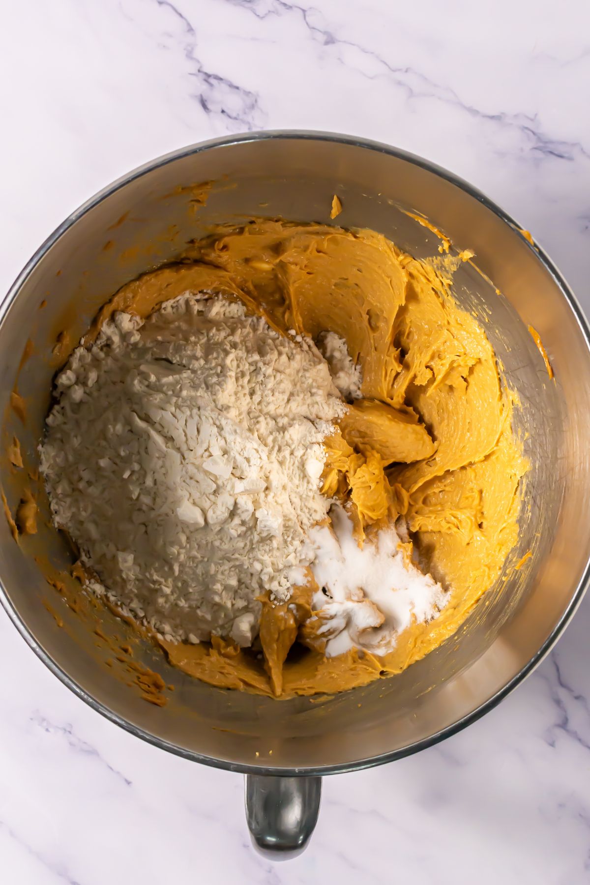 Adding flour to mixing bowl.