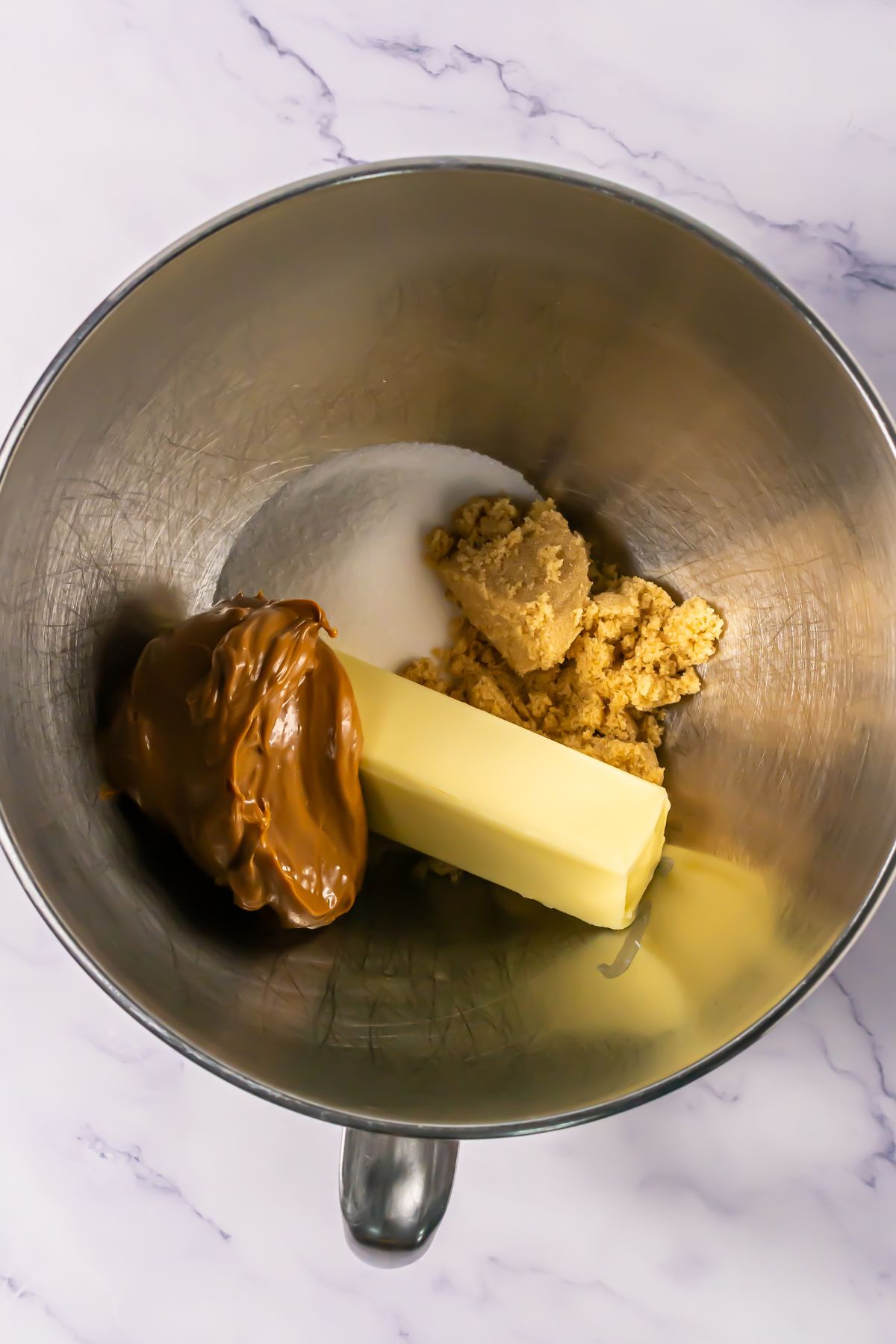 Cookie butter, sugar and butter in a bowl.
