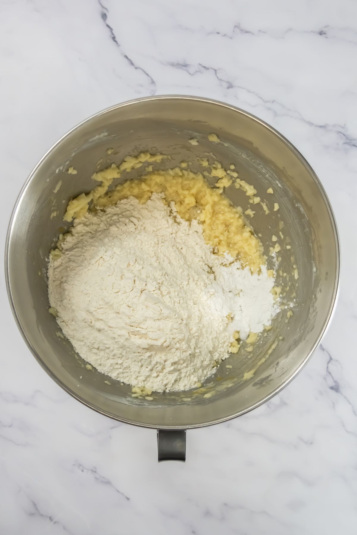 Adding flour into cookie dough.
