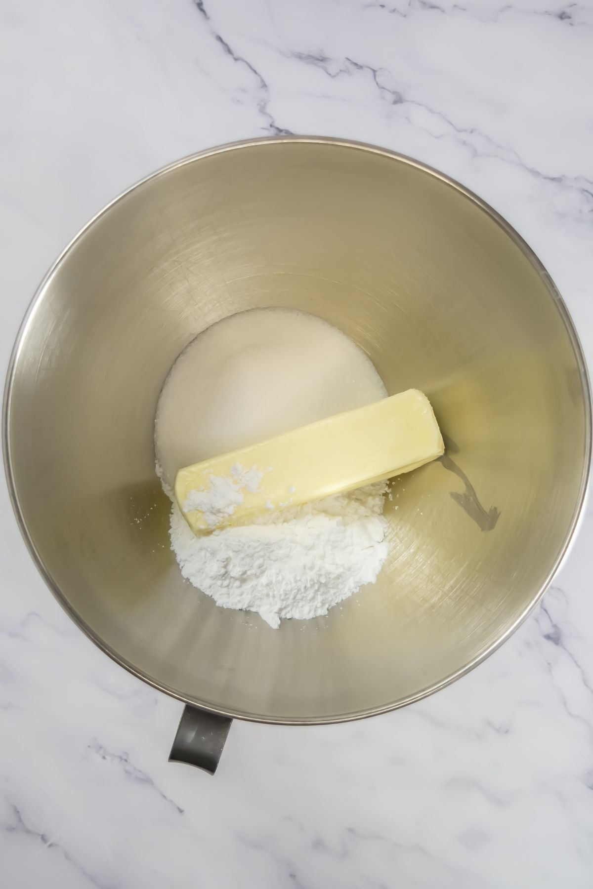 Butter and sugar in a mixing bowl.