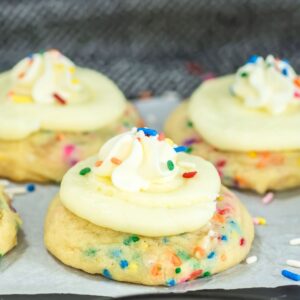 Crumbl funfetti cookies on parchment paper.