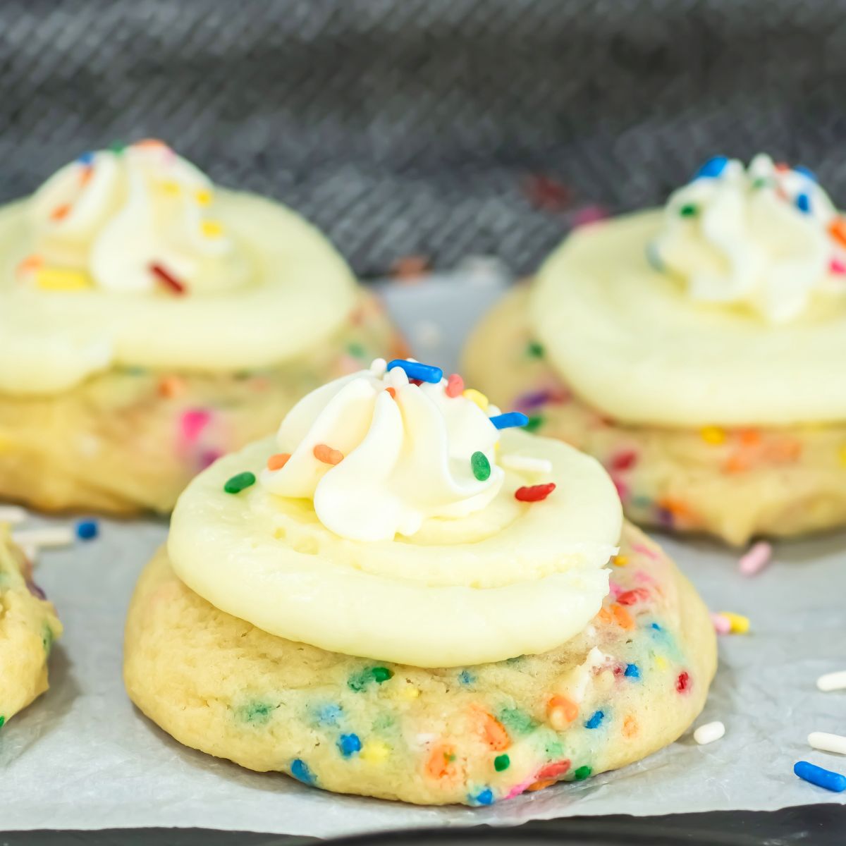 Crumbl funfetti cookies on parchment paper.