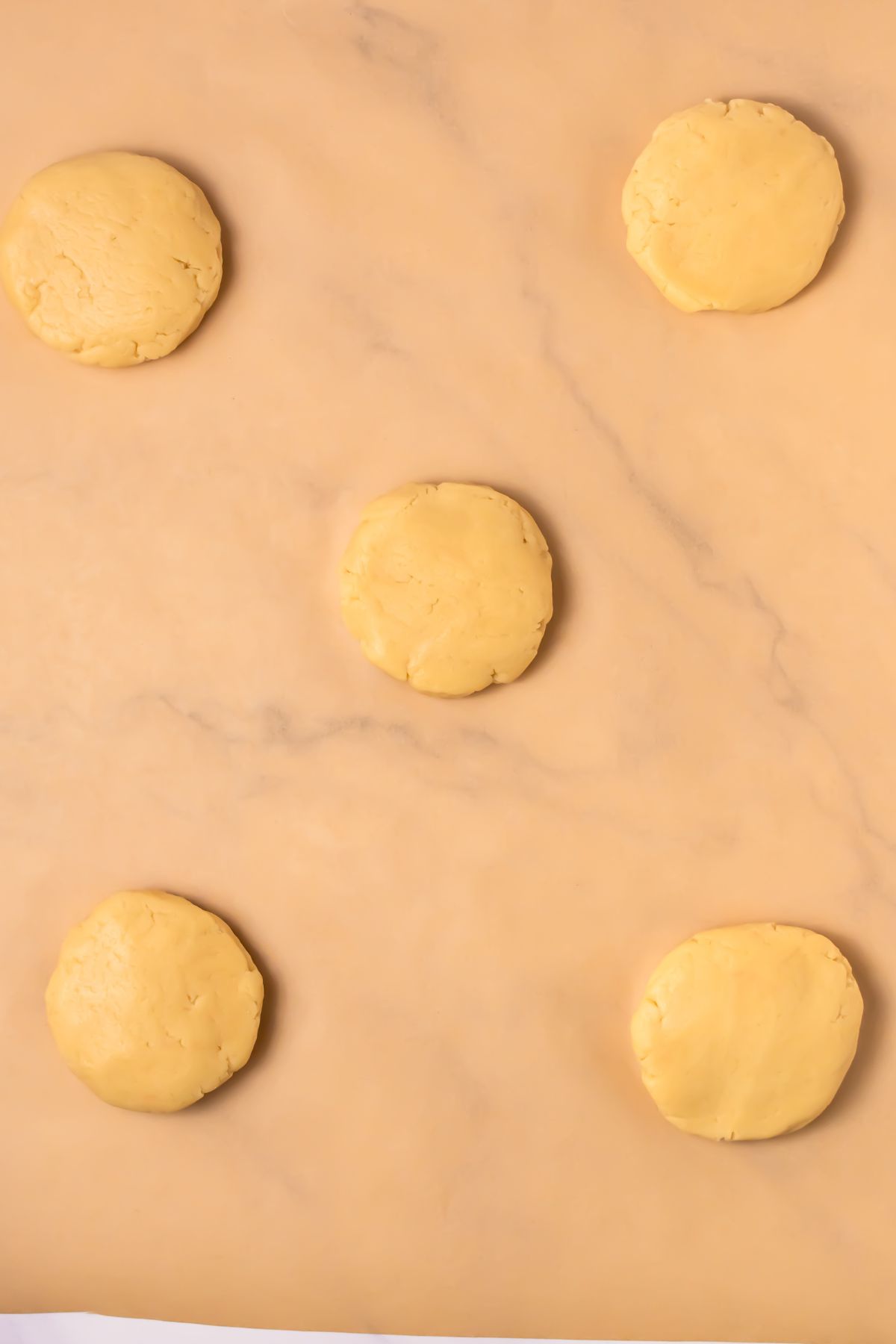 Sugar cookie dough on parchment paper.