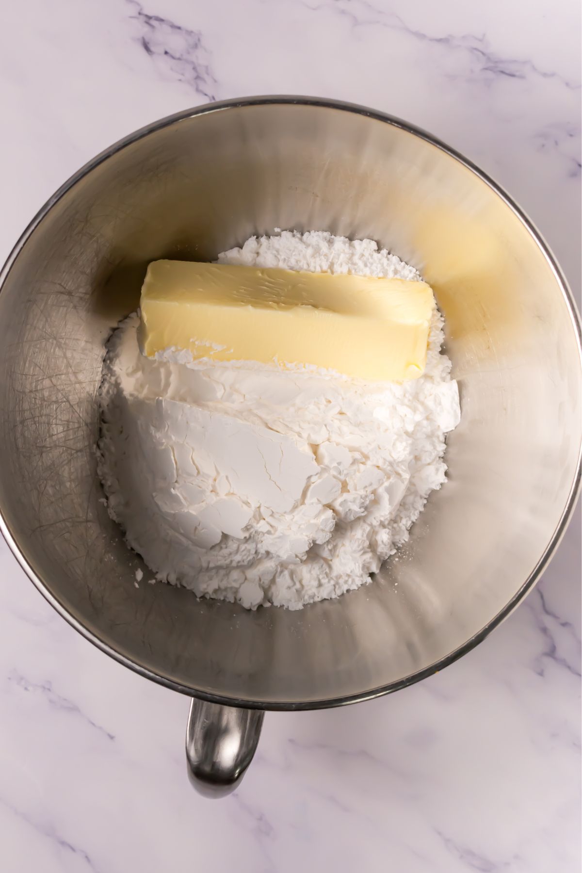 Butter and sugar in a mixing bowl.