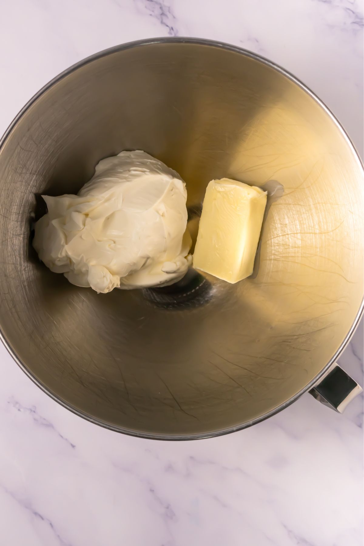 Butter and cream in a mixing bowl.