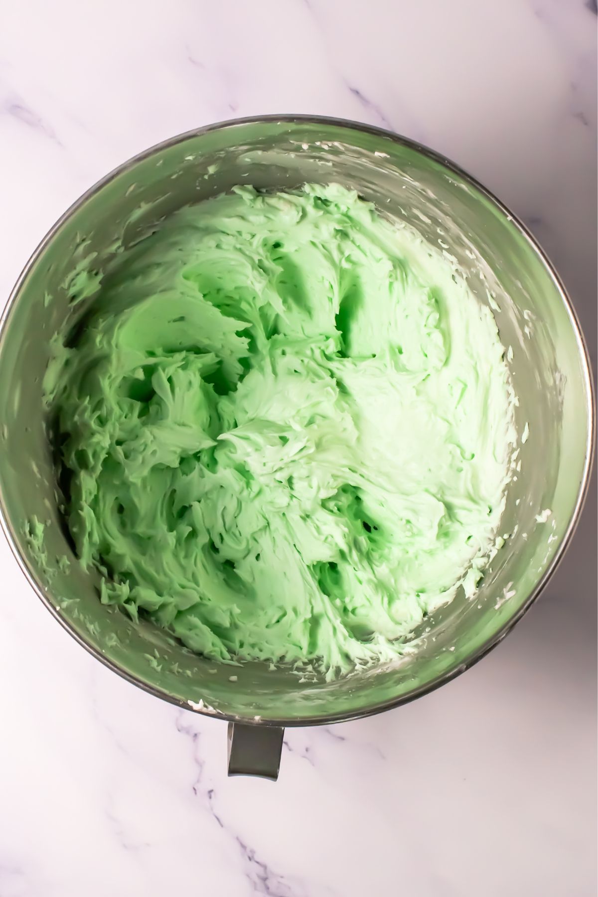 Green frosting in a bowl.