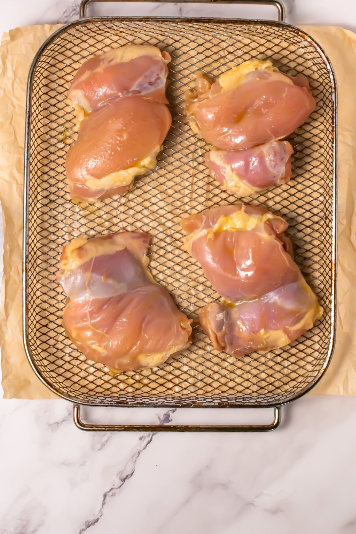 Chicken thighs in an air fryer.