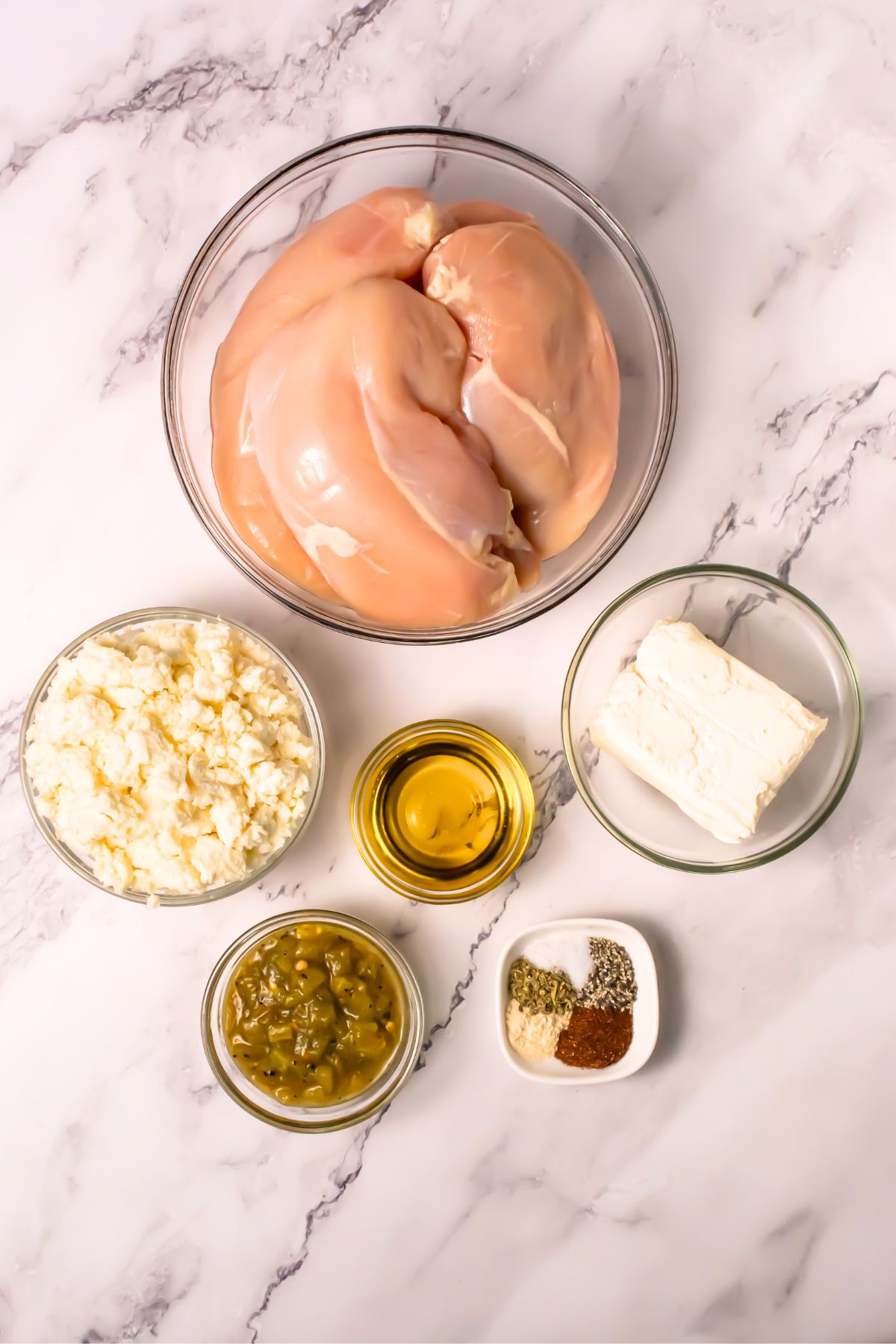 Stuffed chicken ingredients on a marble counter.