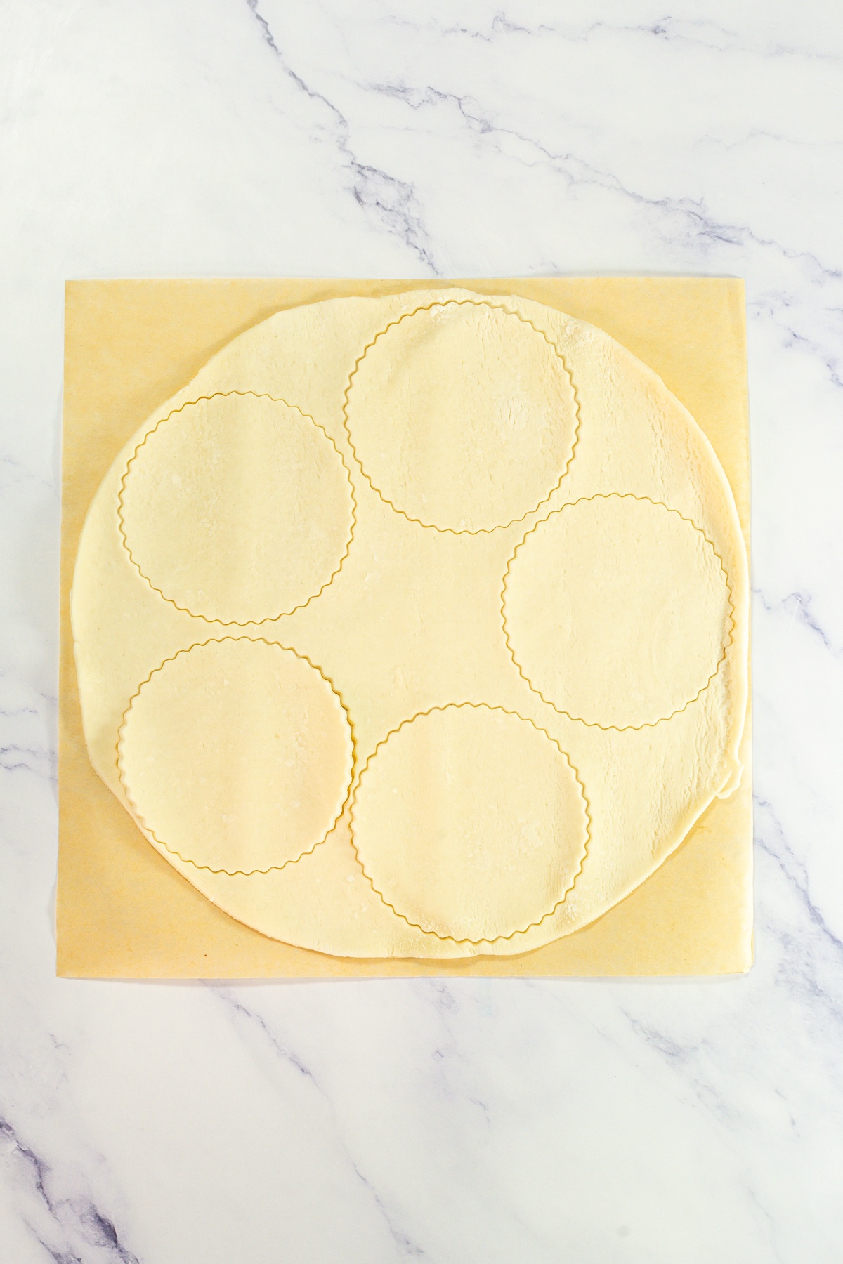 Pie crusts added into cupcake tin.