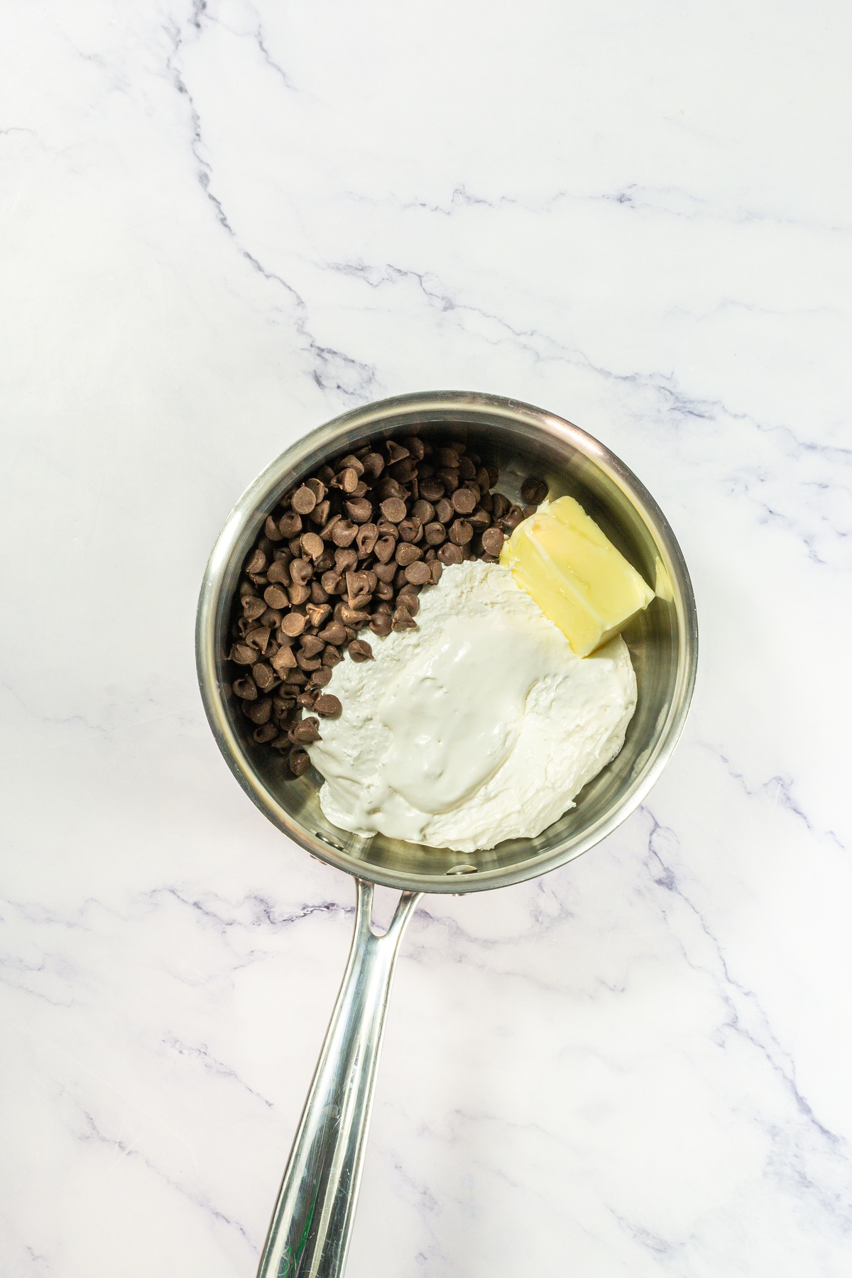 Butter, sugar and chocolate chips in a pan.