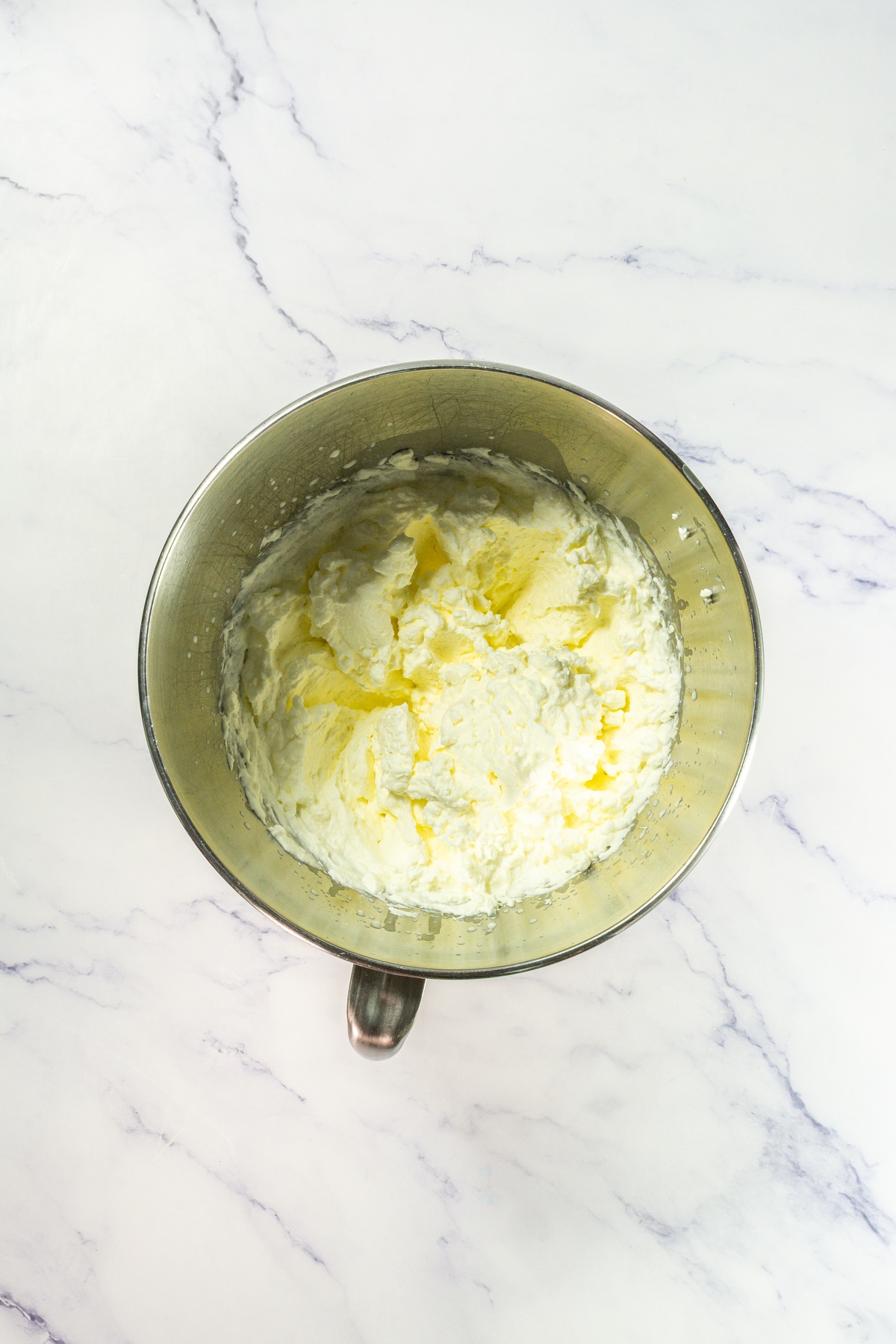 Whipped cream in a mixing bowl.