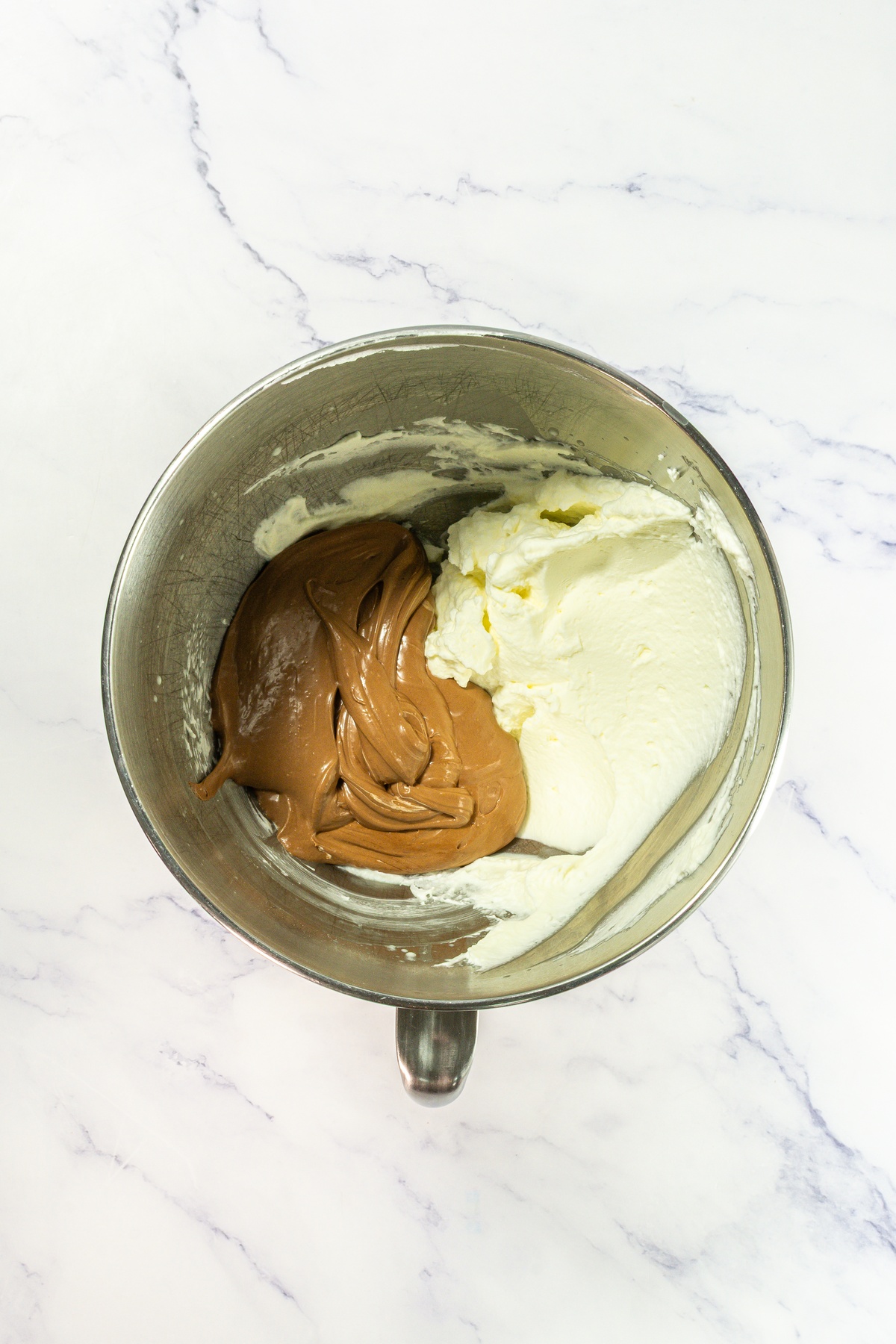 Chocolate filling and whipped cream in a bowl.