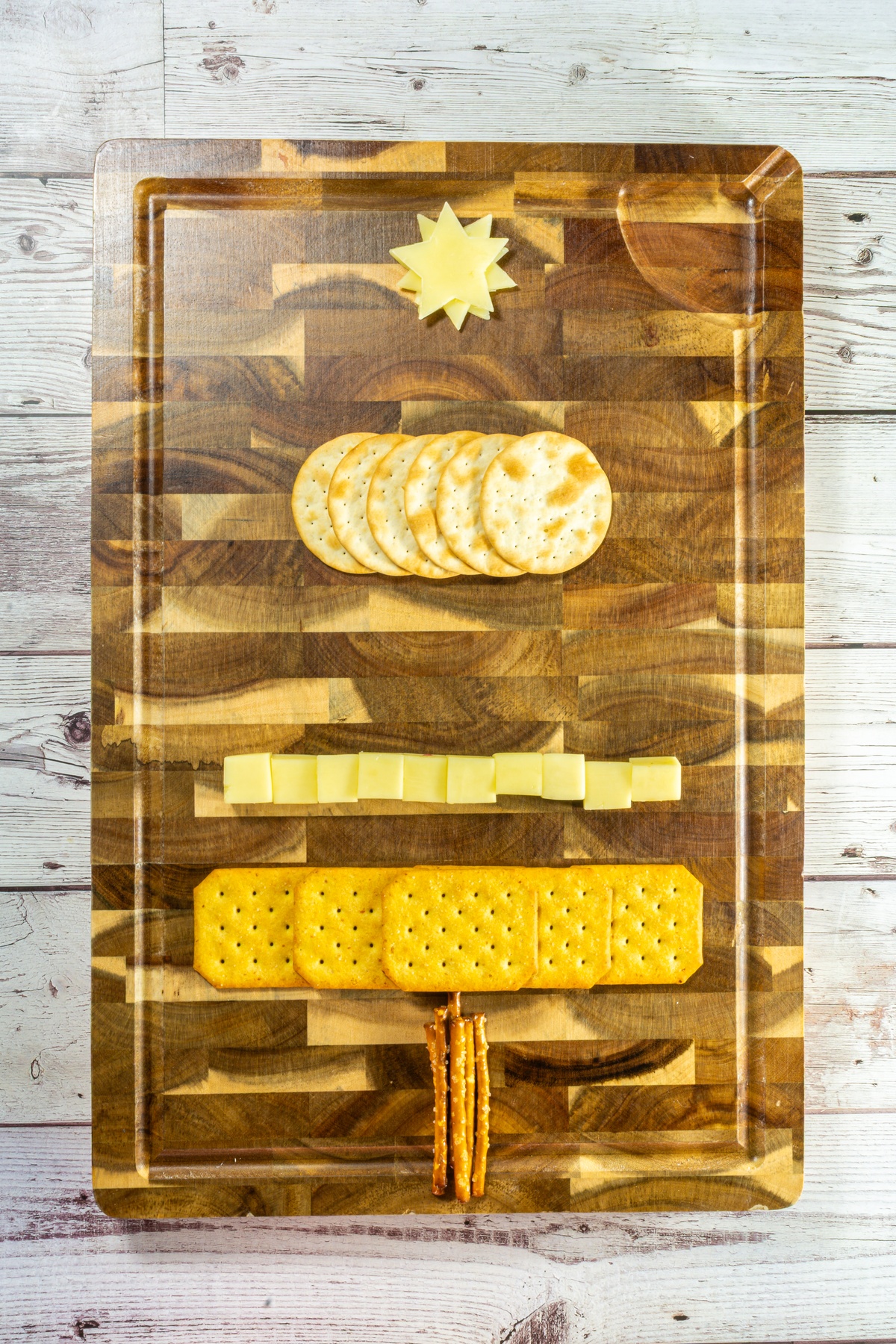 Cheese and crackers on a charcuterie board.