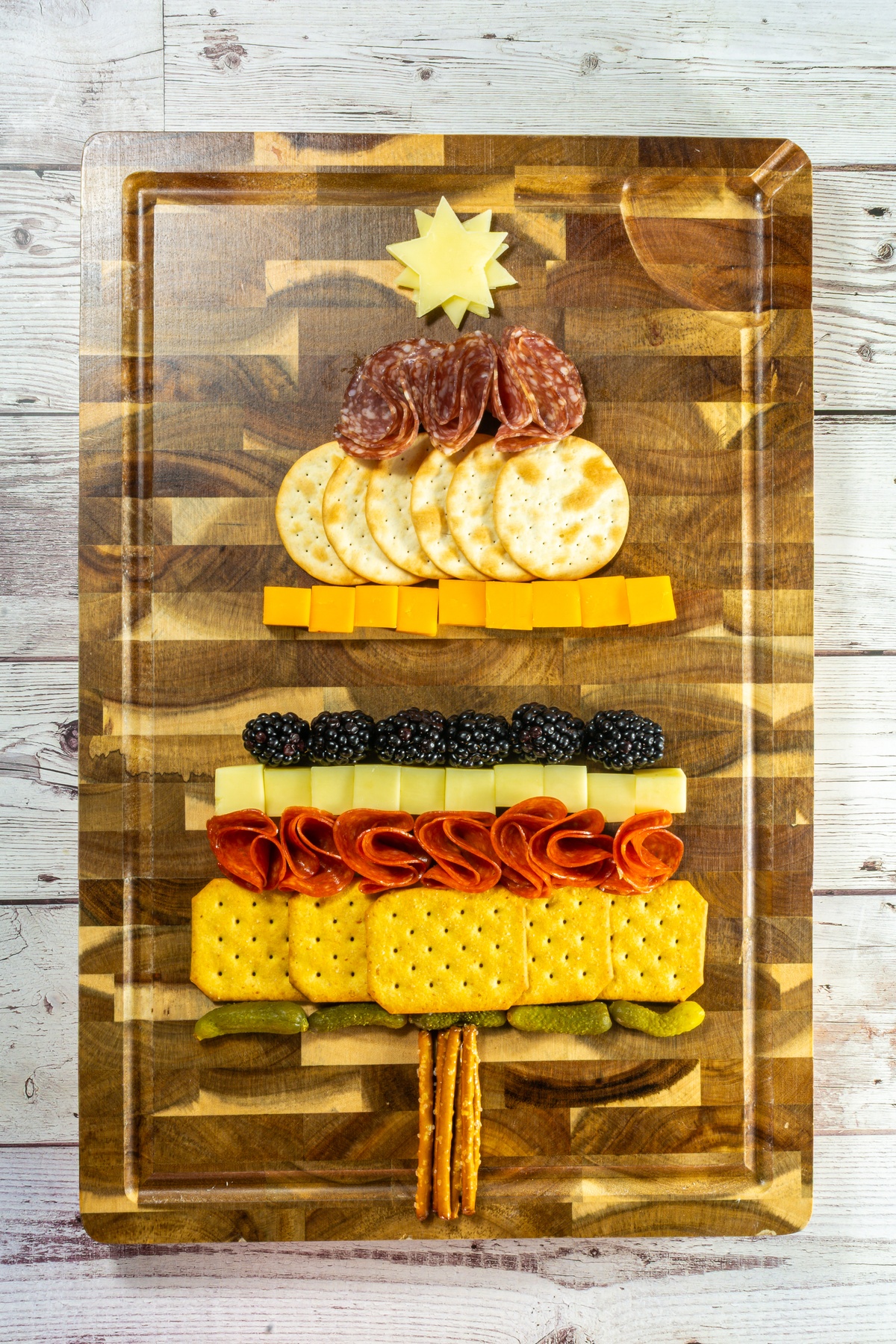 Meats and berries layered onto board.