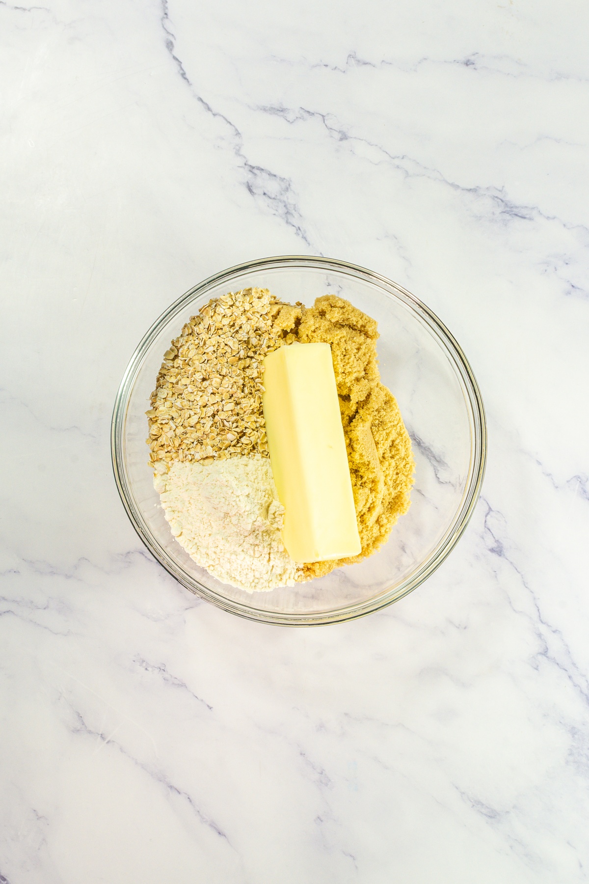 Butter, sugar and dry ingredients in a bowl.