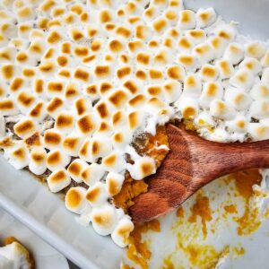 Sweet potato casserole with marshmallows in a serving dish.