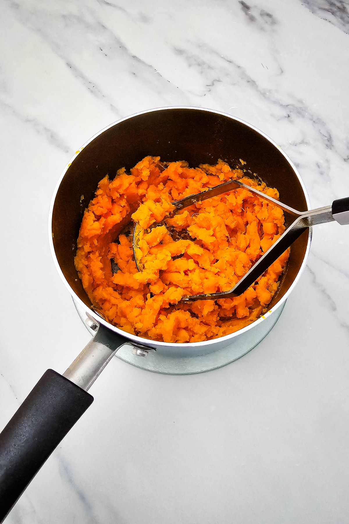 Mashed sweet potatoes in a pot.