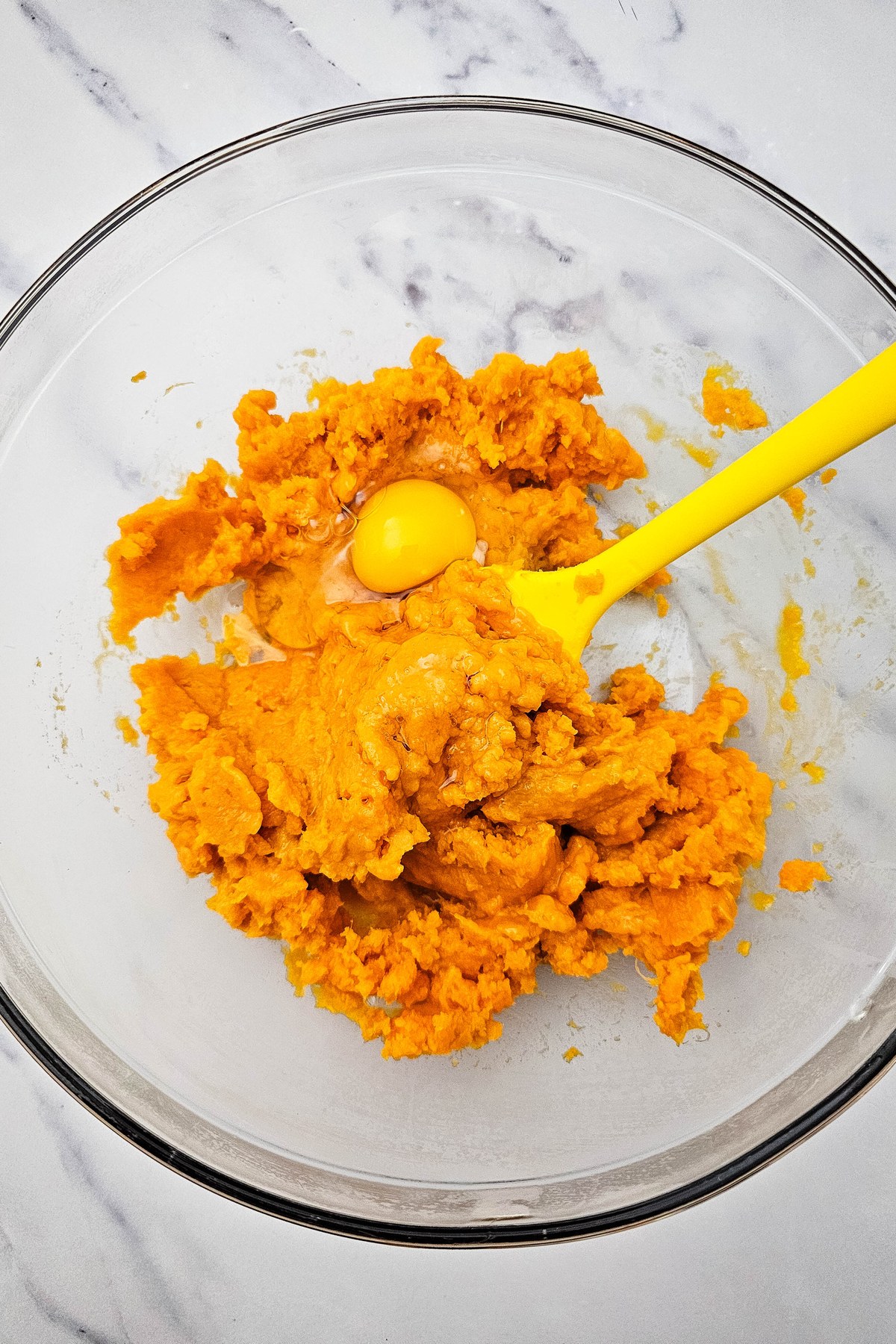 Mashed sweet potatoes with eggs in a bowl.