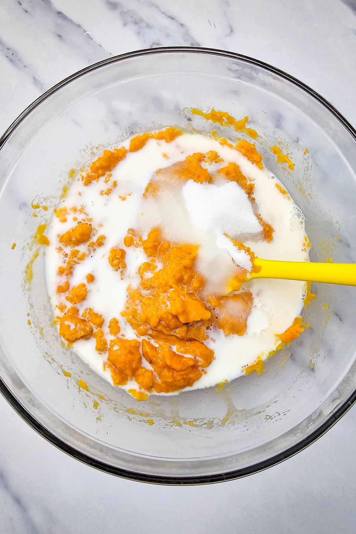 Milk added to mashed sweet potatoes.