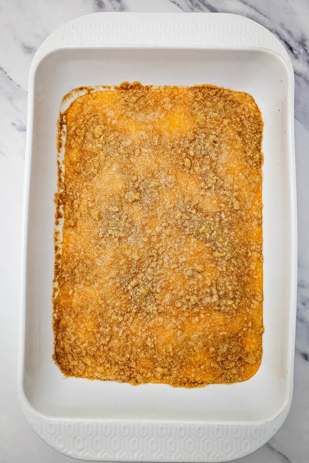 Crumble mixture sprinkled over sweet potatoes.