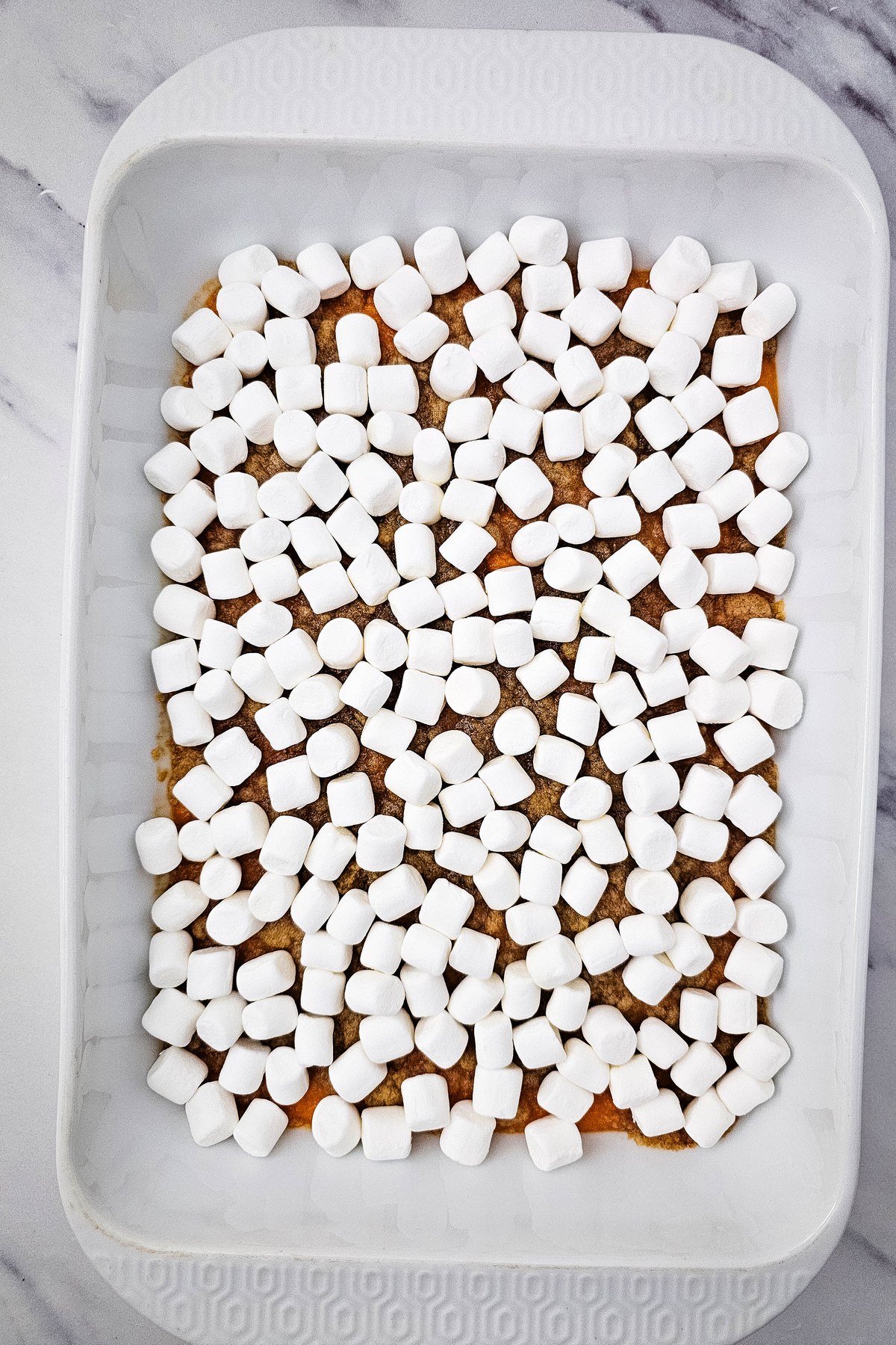 Marshmallows added to top of sweet potato casserole.