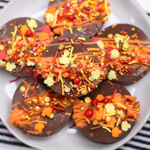 Fall oreos stacked on a plate.