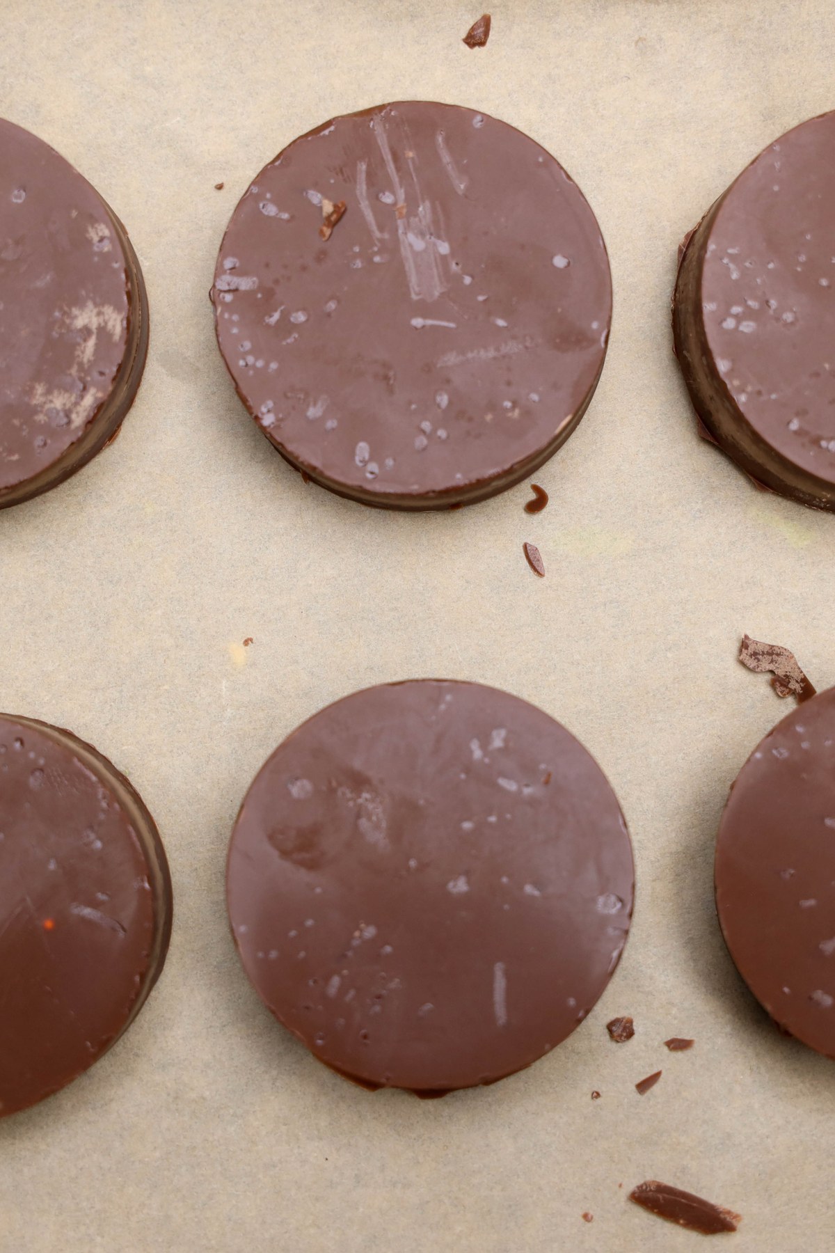 Chocolate covered oreos on parchment paper.