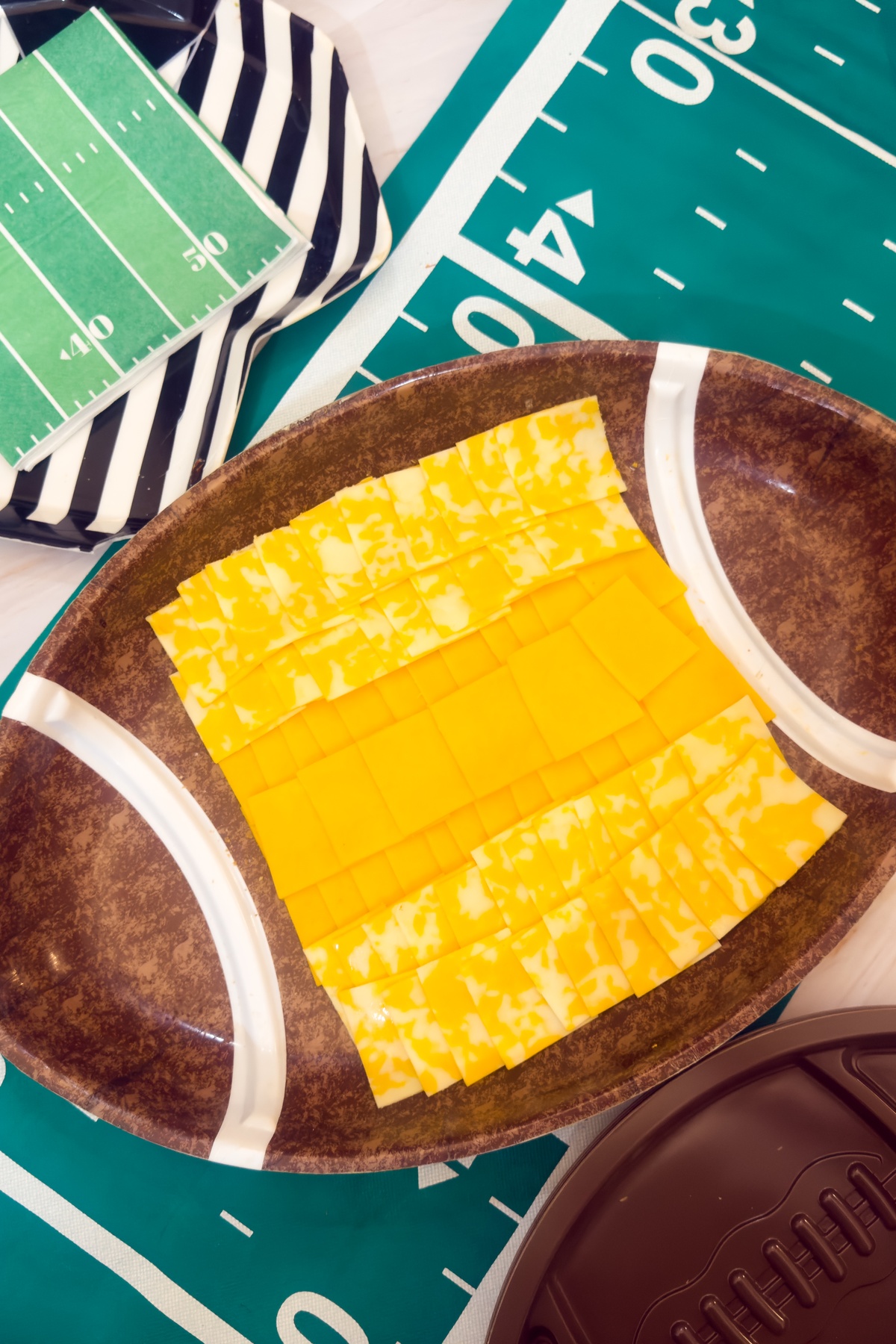 Cheese layered on a football shaped dish.