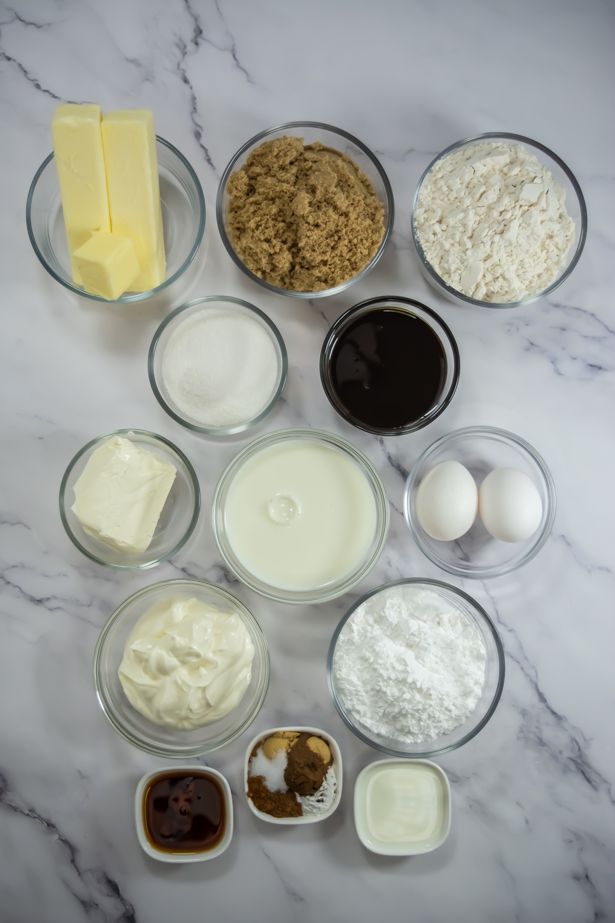 Ingredients for gingerbread bundt cake on a marble table.