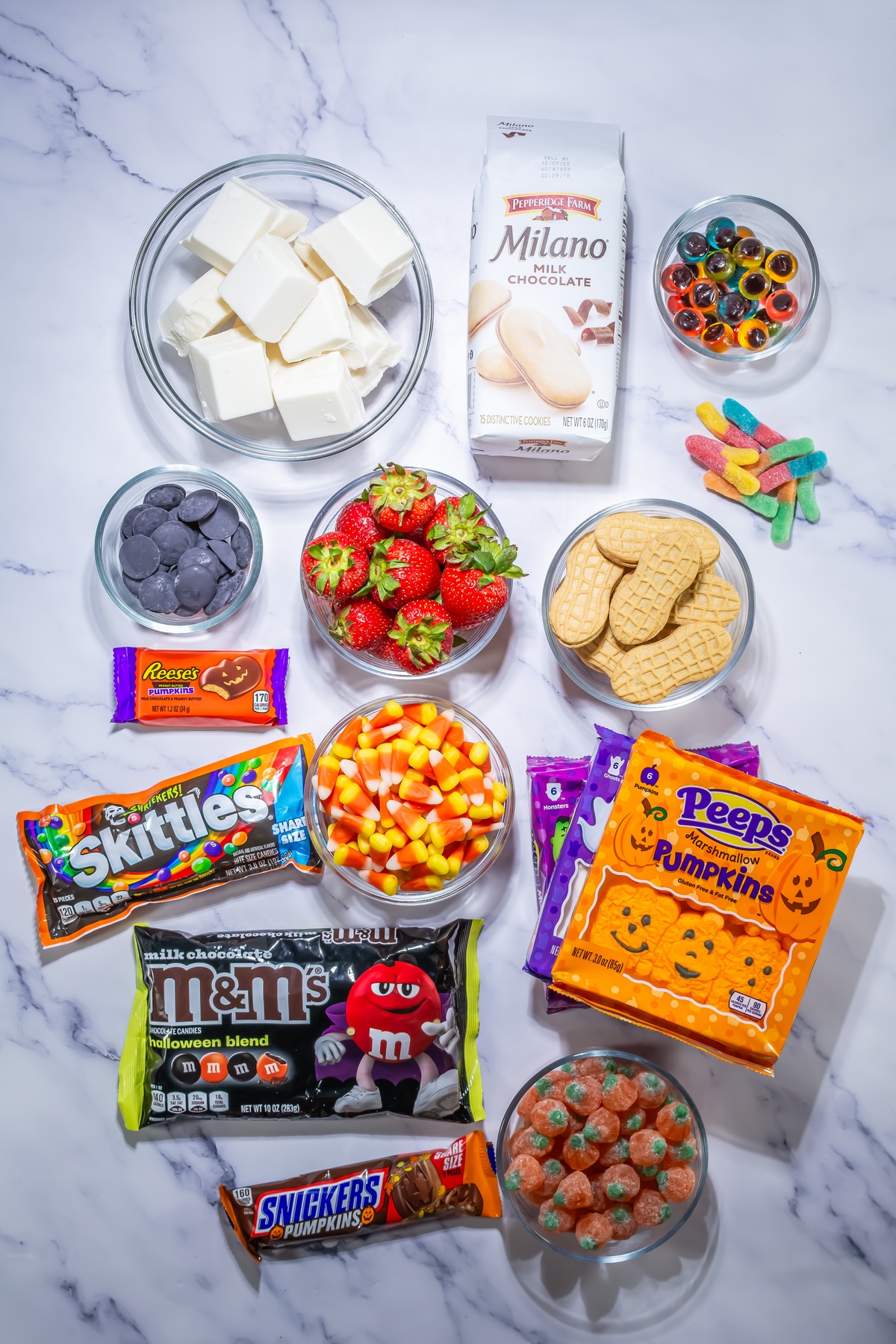 Spooky Halloween dessert board ingredients on a table.