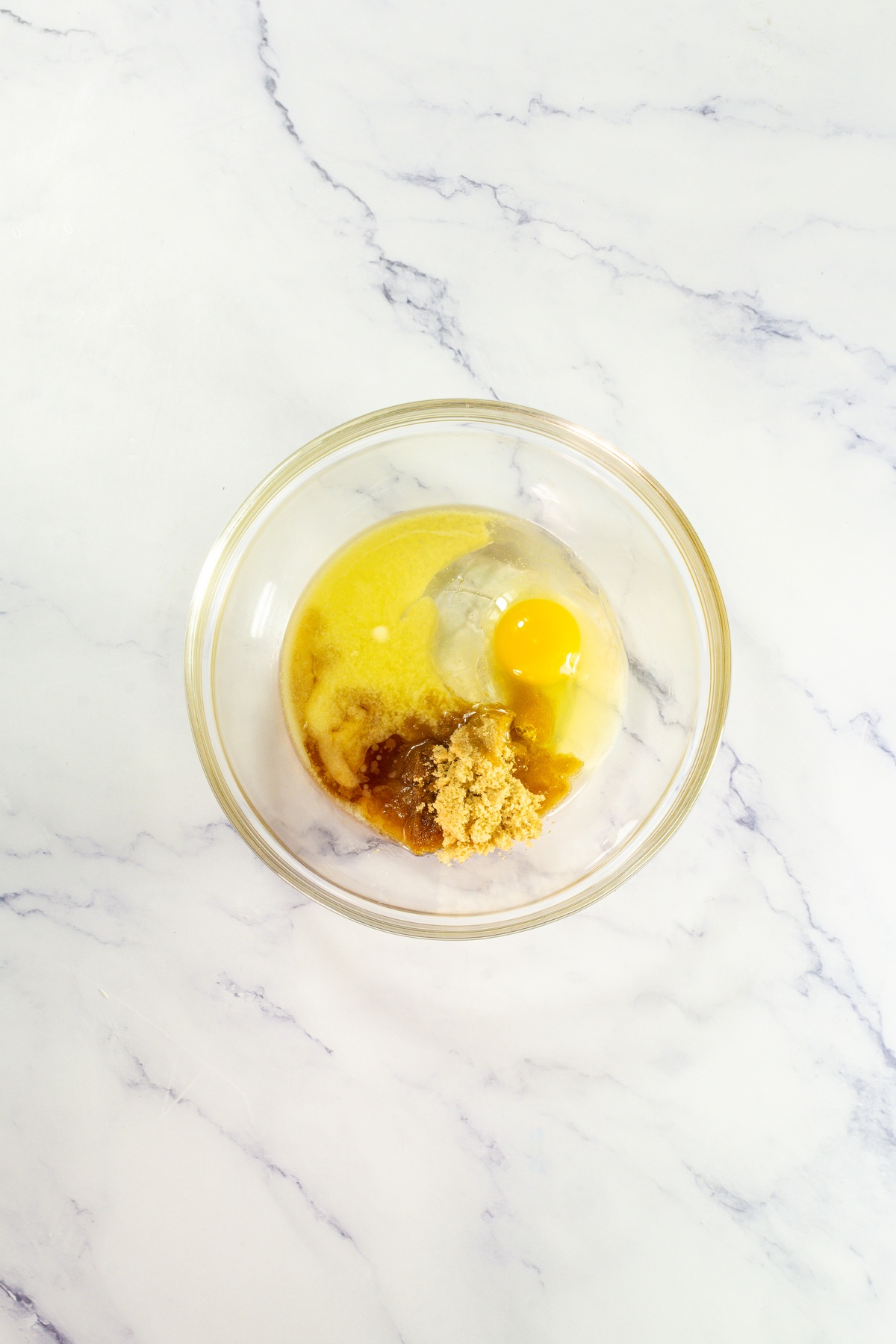 Melted butter, eggs and sugar in a bowl.
