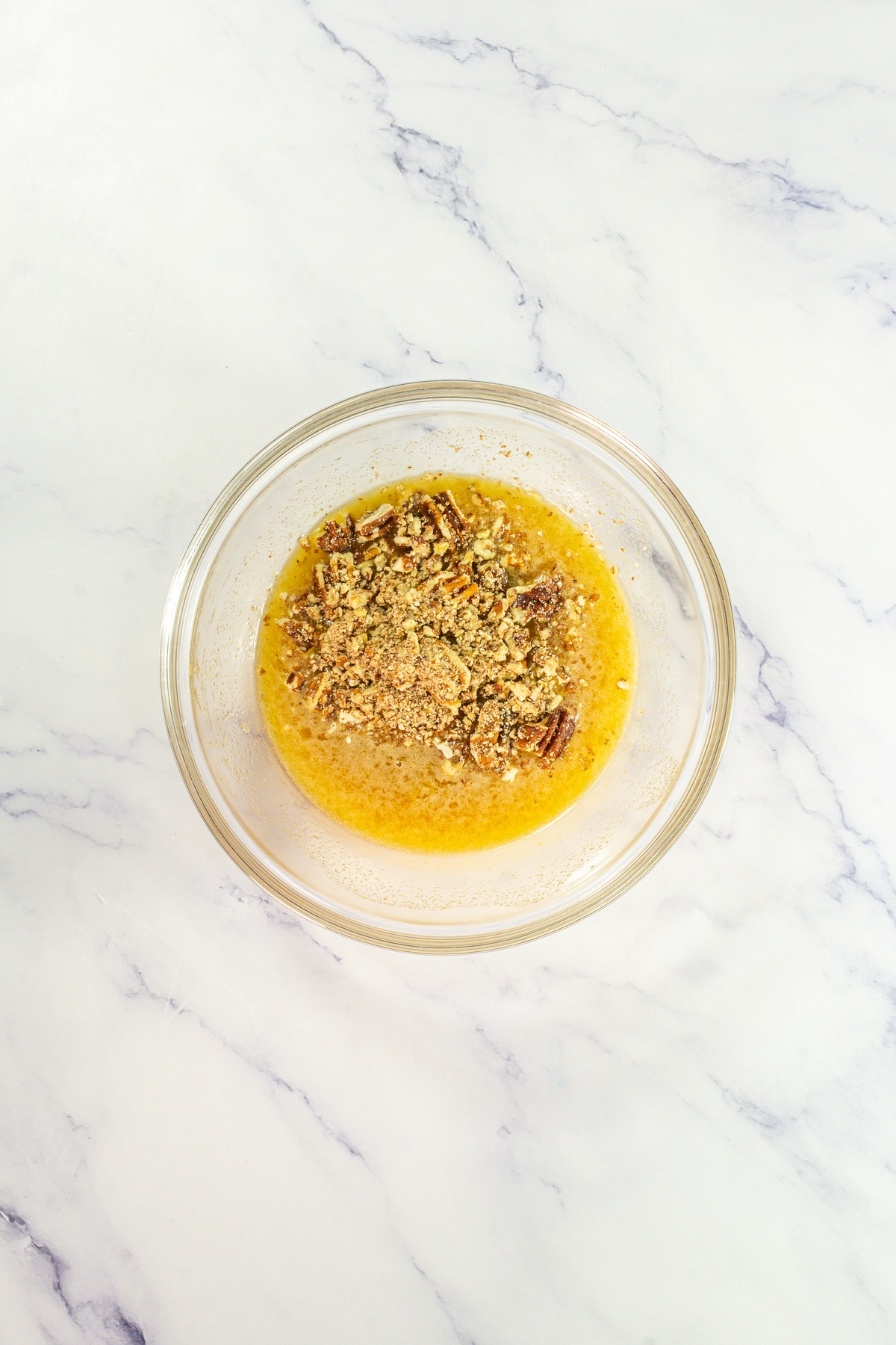 Melted butter with chopped pecans.