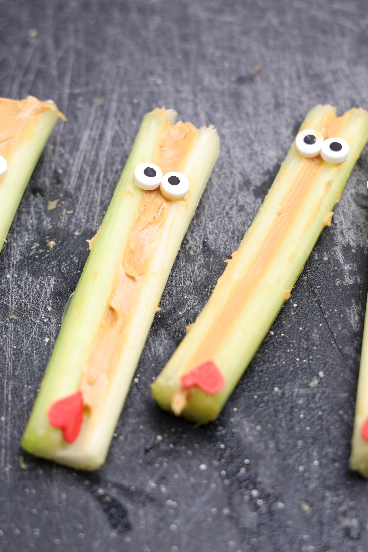 Celery sticks with peanut butter, candy heart and candy eyes.