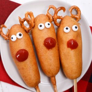 Rudolph decorated corn dogs on a plate.