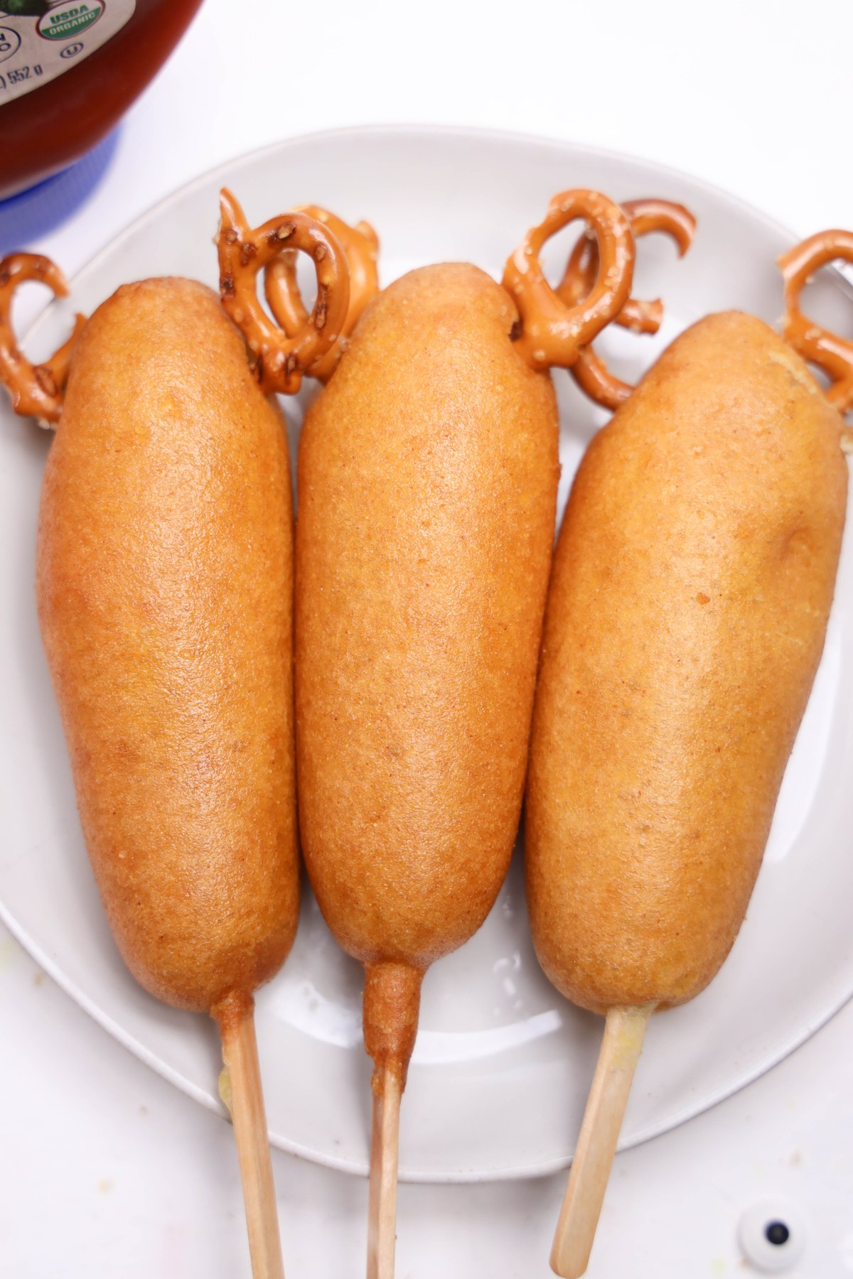 Corn dogs with pretzels added to the tops.
