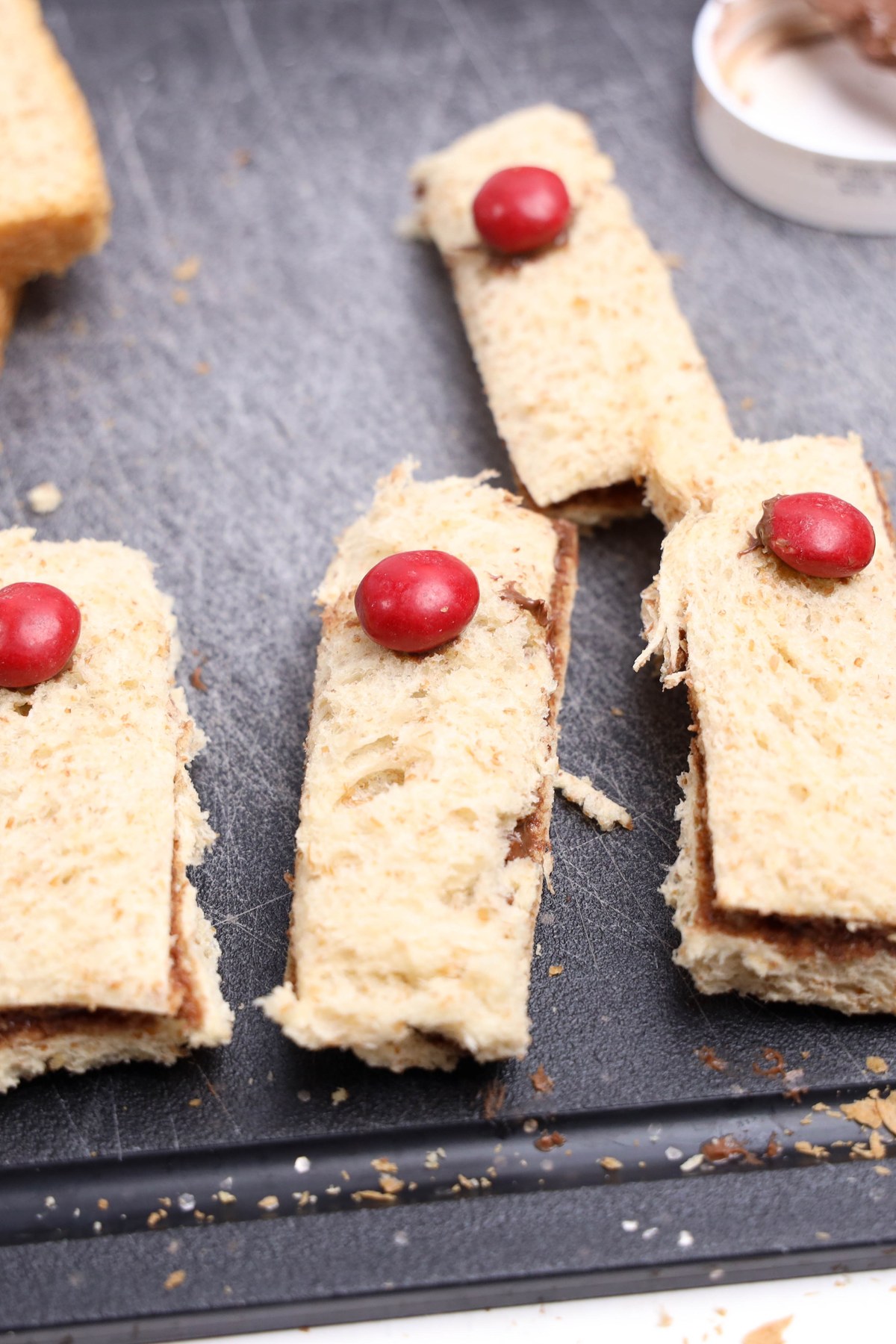 Nutella sandwiches with red candies added to them.