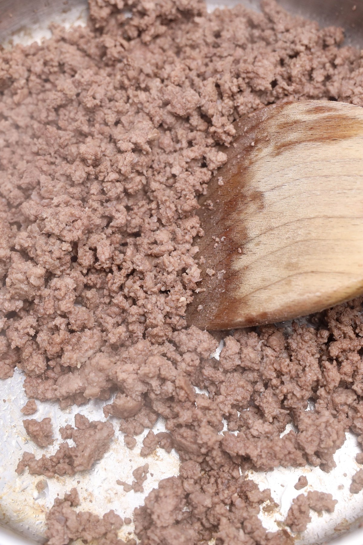 Ground beef cooked in a pan.