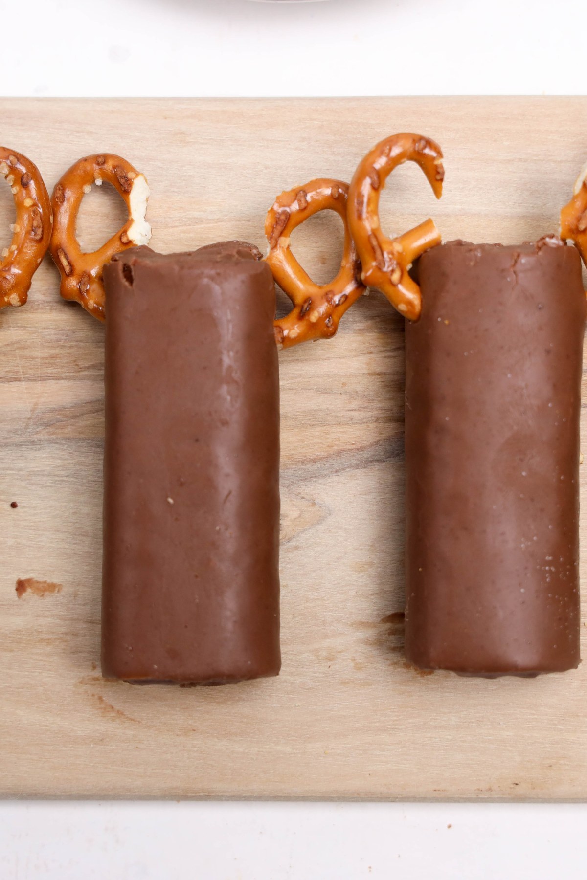 Swiss rolls with pretzels added to the tops.