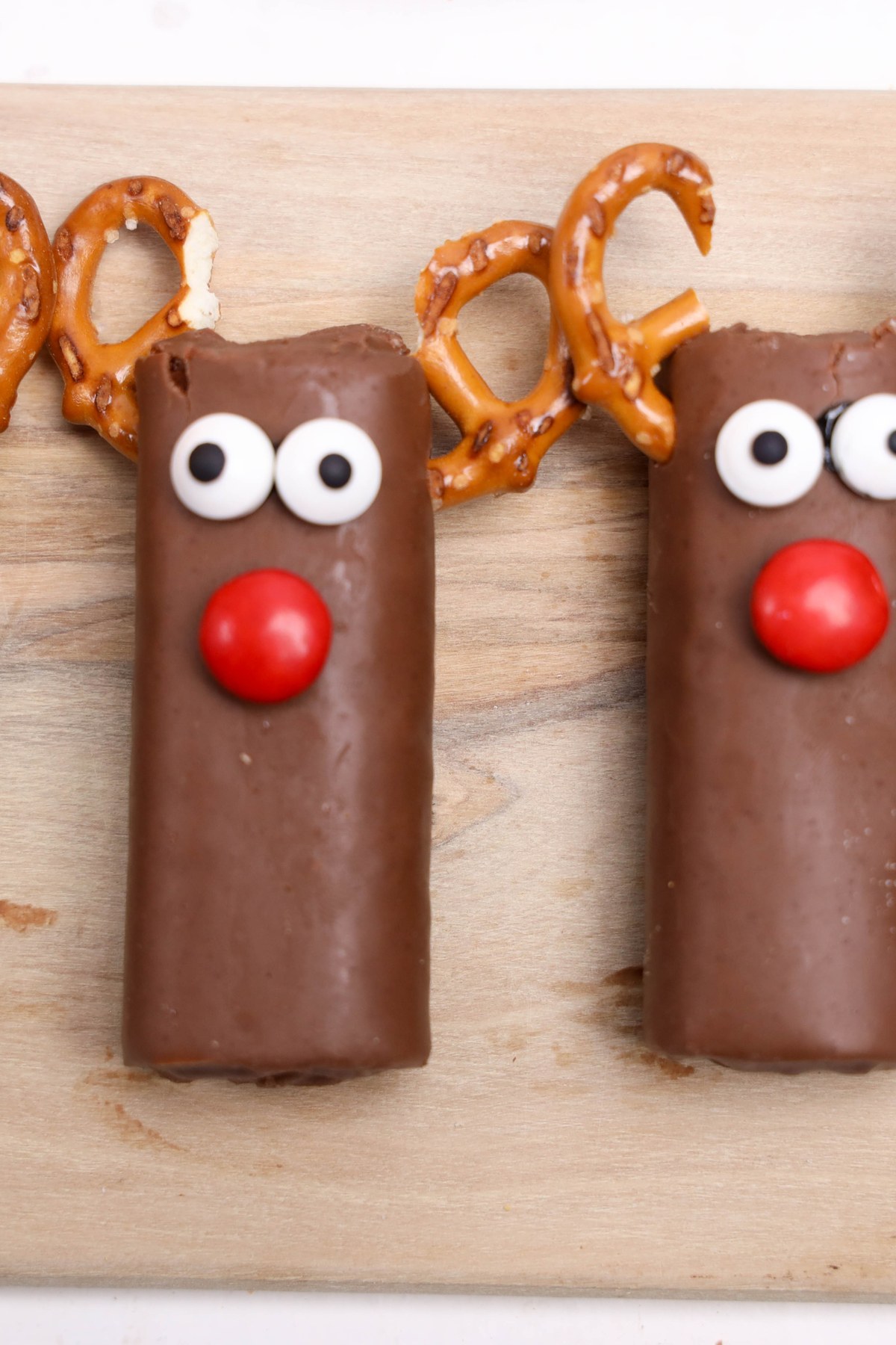 Swiss rolls with red candies and candy eyes added to them.