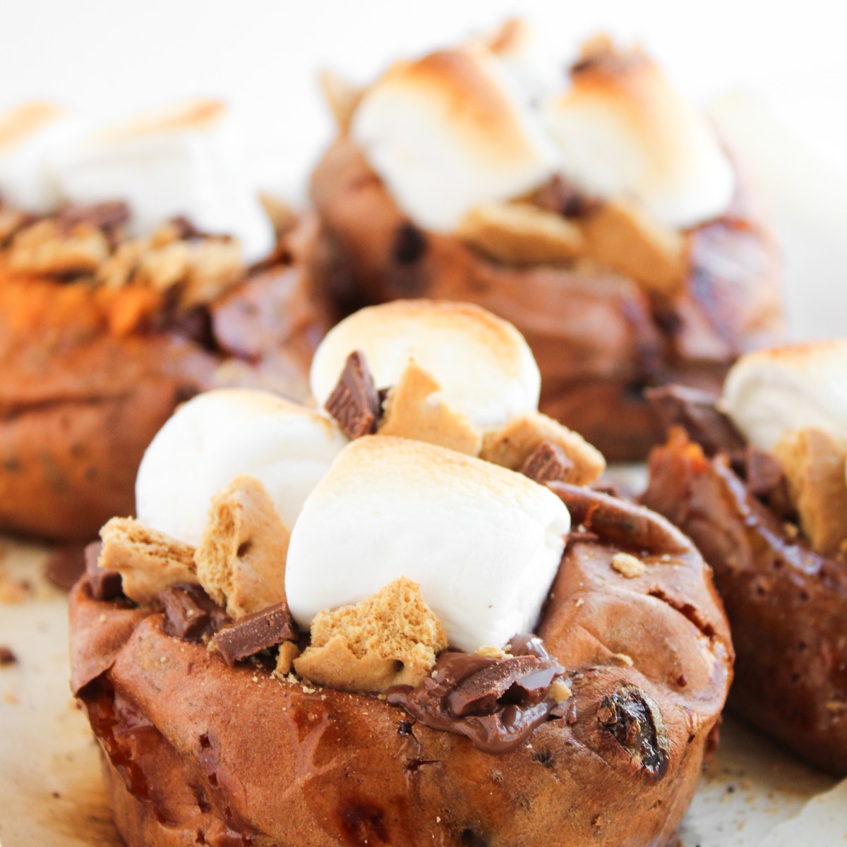 Smores stuffed sweet potatoes on a plate.