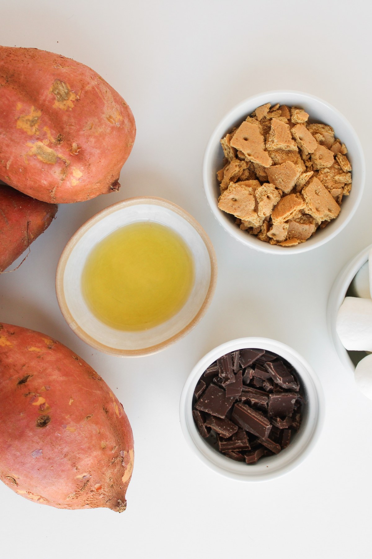 Smores stuffed sweet potatoes ingredients on a counter.