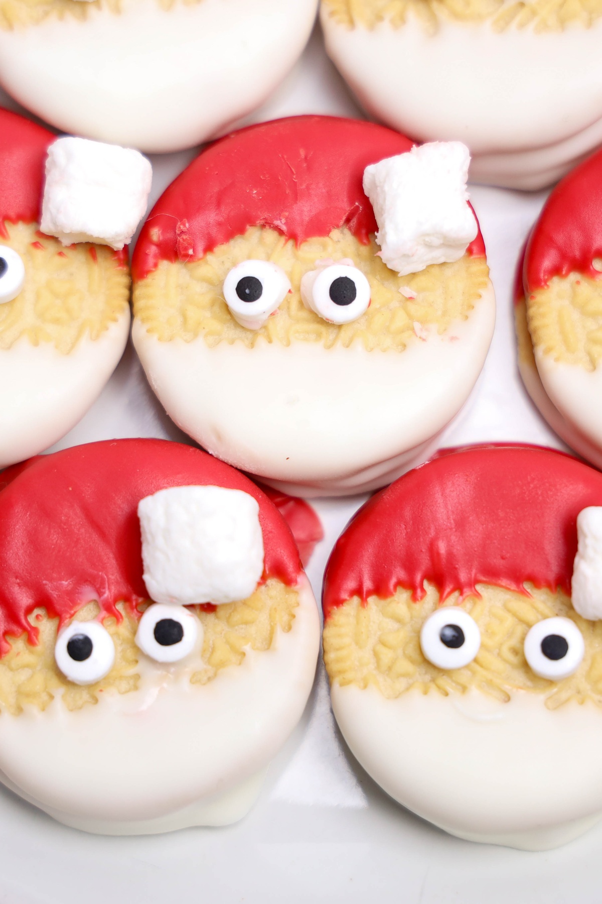 Decorated Oreos designed to look like Santa faces.