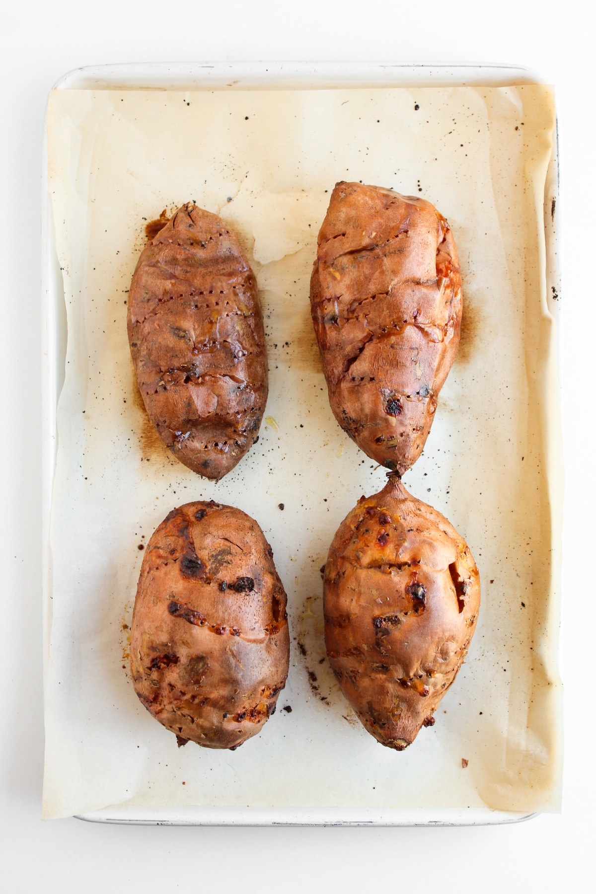 Baked sweet potatoes on a pan.