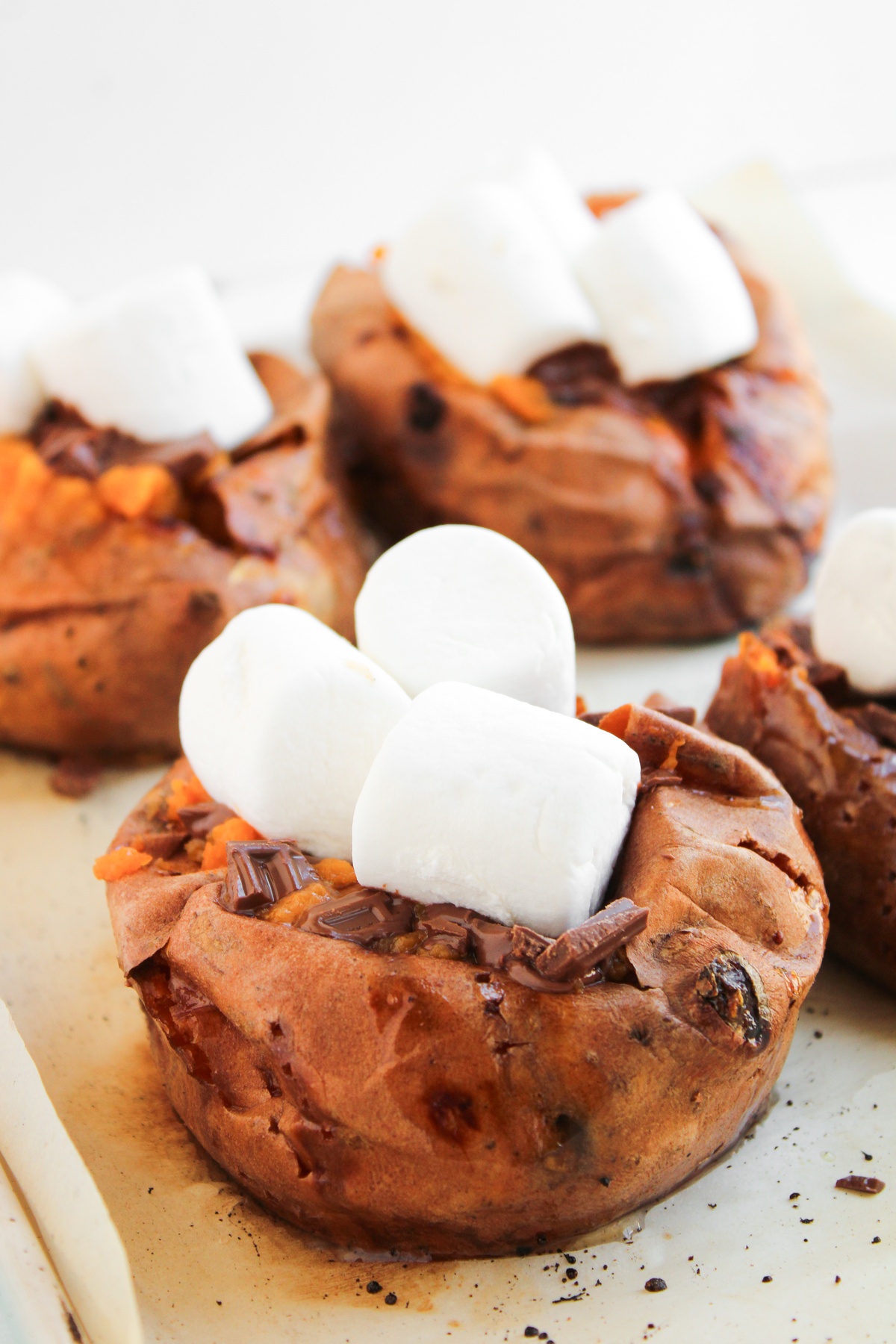 Marshmallows added to tops of sweet potatoes.