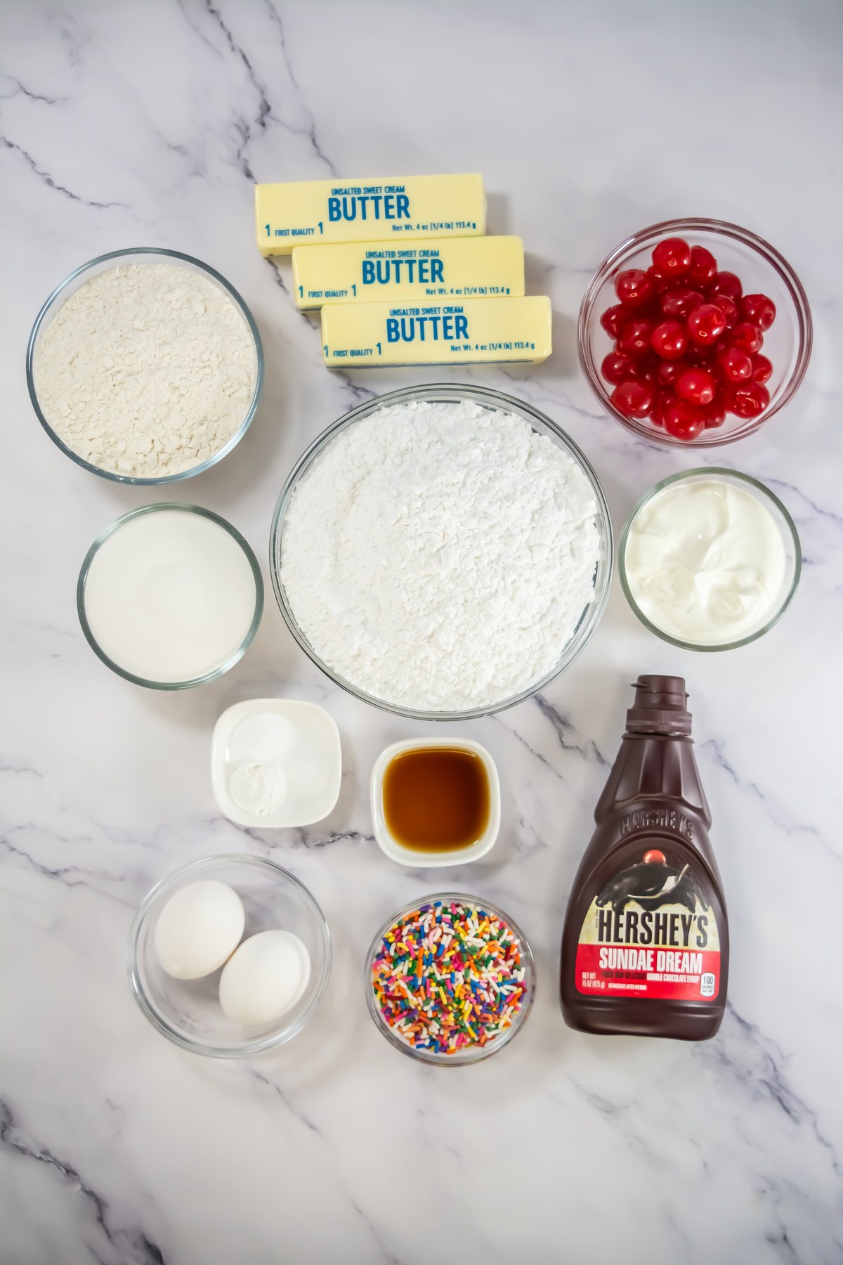 Sundae cupcakes ingredients on a counter.
