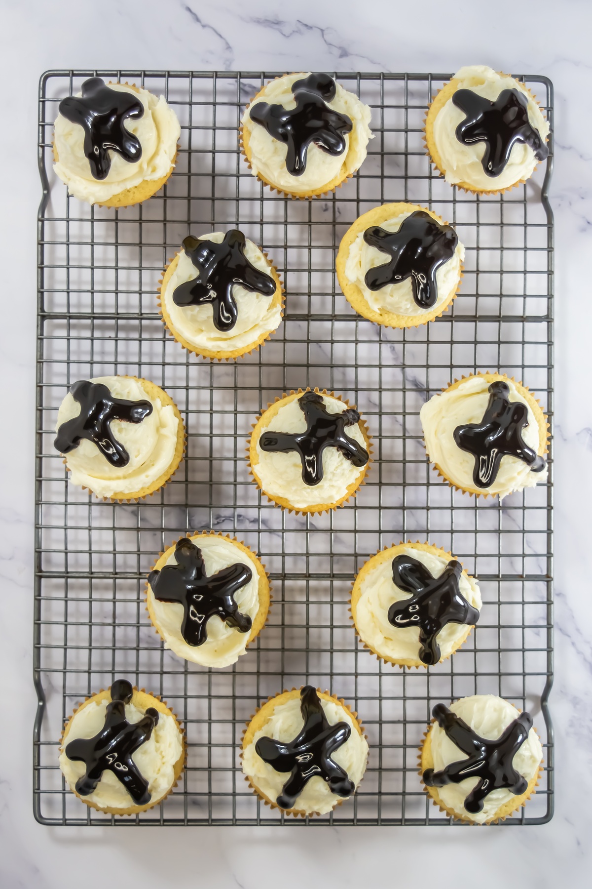Chocolate sauce added to tops of cupcakes.