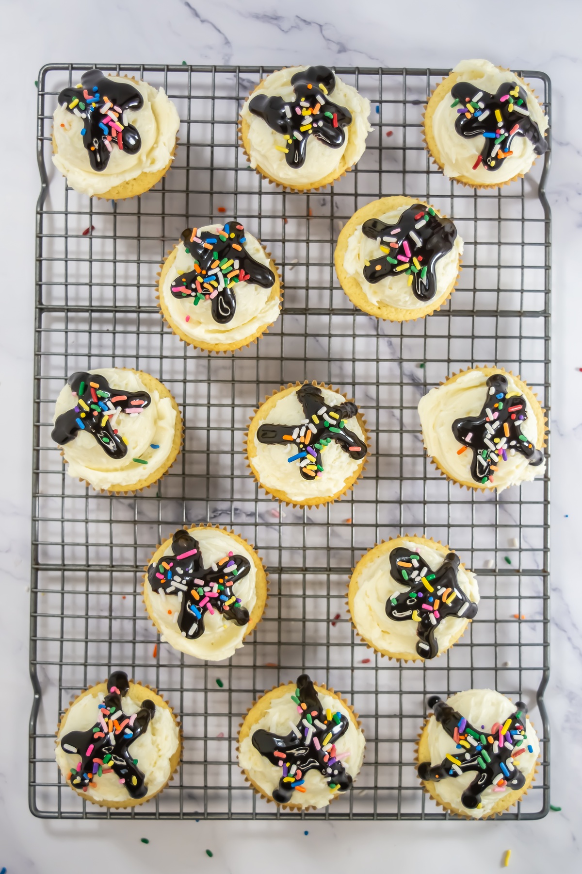 Sprinkles added to tops of cupcakes.
